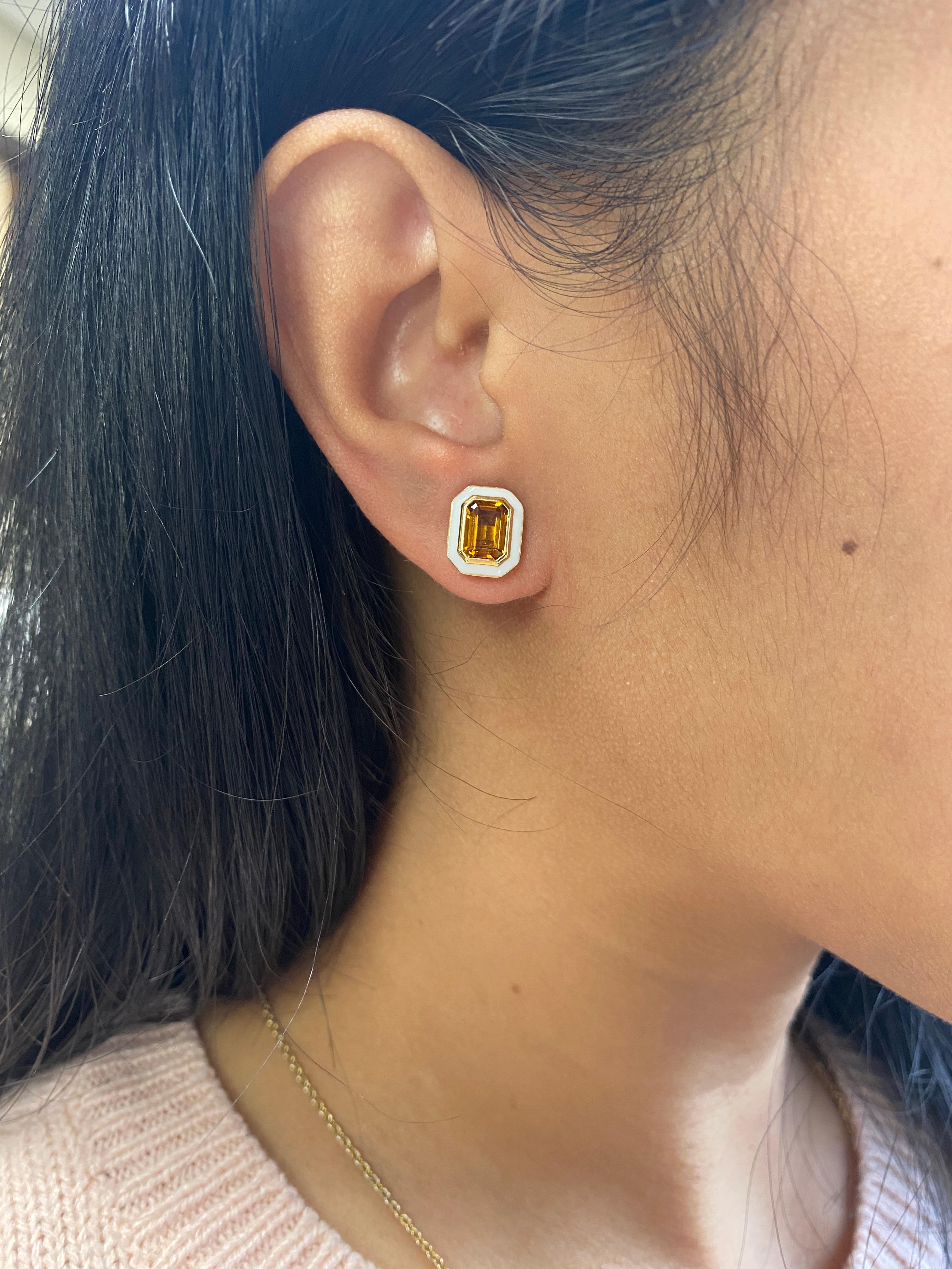 These earrings are a unique combination of Citrine and White enamel. If you want to make a statement these are the perfect earrings to do it!

A pair of 7 x 5 mm Citrine Emerald Cut studs earrings with White enamel. The studs have posts and are held