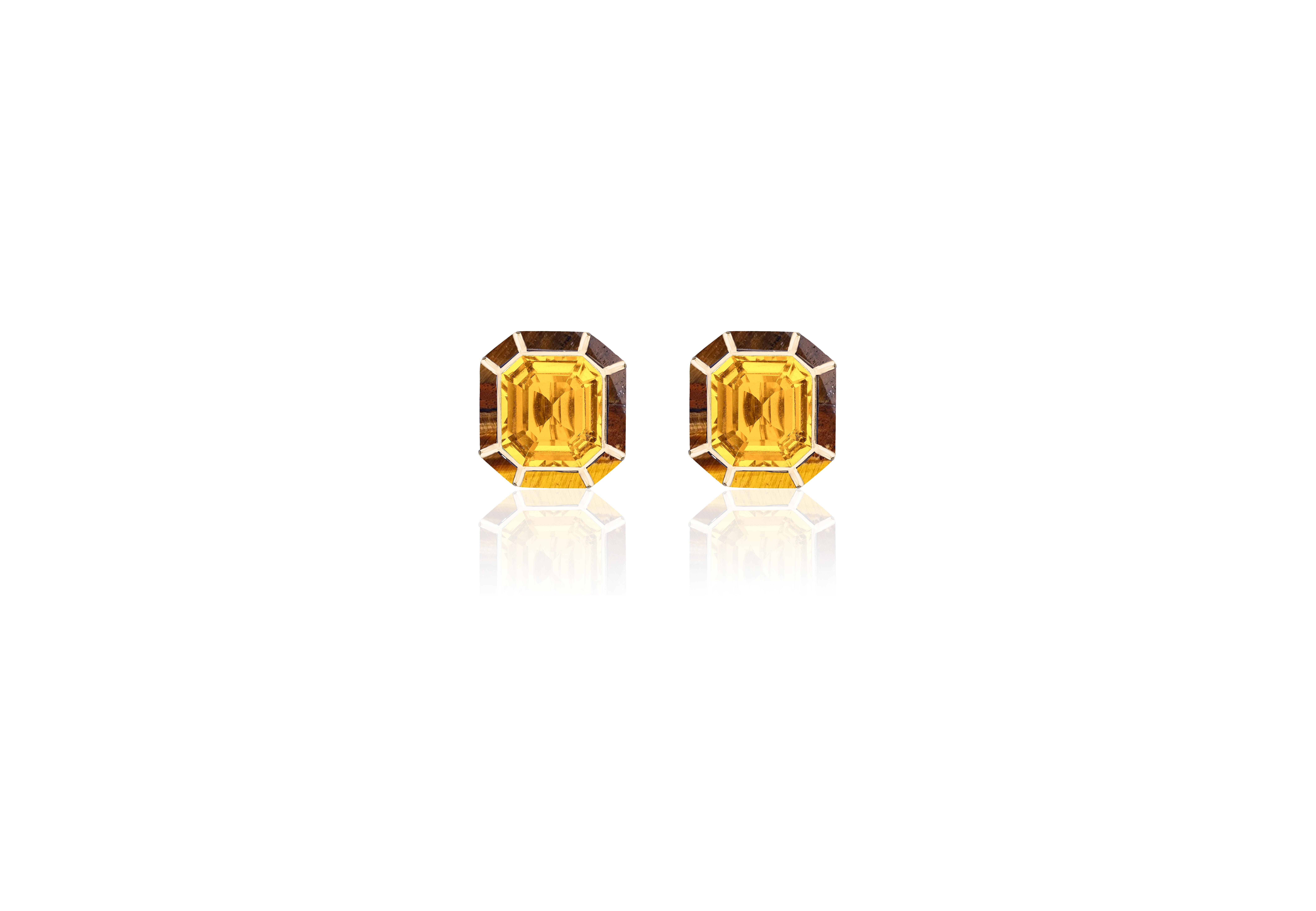 The Citrine & Tiger's Eye Stud Earrings from the 'Melange' Collection showcase a captivating blend of elegance and charm. Crafted with exquisite attention to detail, these earrings feature stunning emerald cut Citrine and Tiger's Eye gemstones set