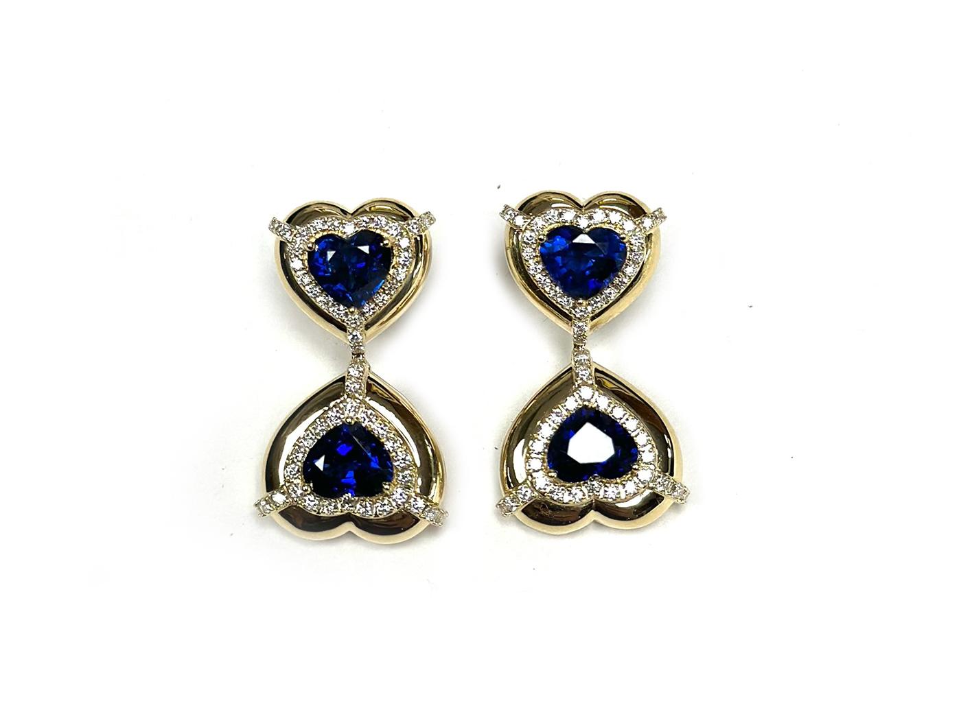 These Double Heart Shape Blue Sapphire Earrings with Diamonds in 18K Yellow Gold, part of the 'G-One' Collection, are a stunning display of elegance. These earrings showcase two heart-shaped blue sapphires adorned with diamonds, set in 18K yellow