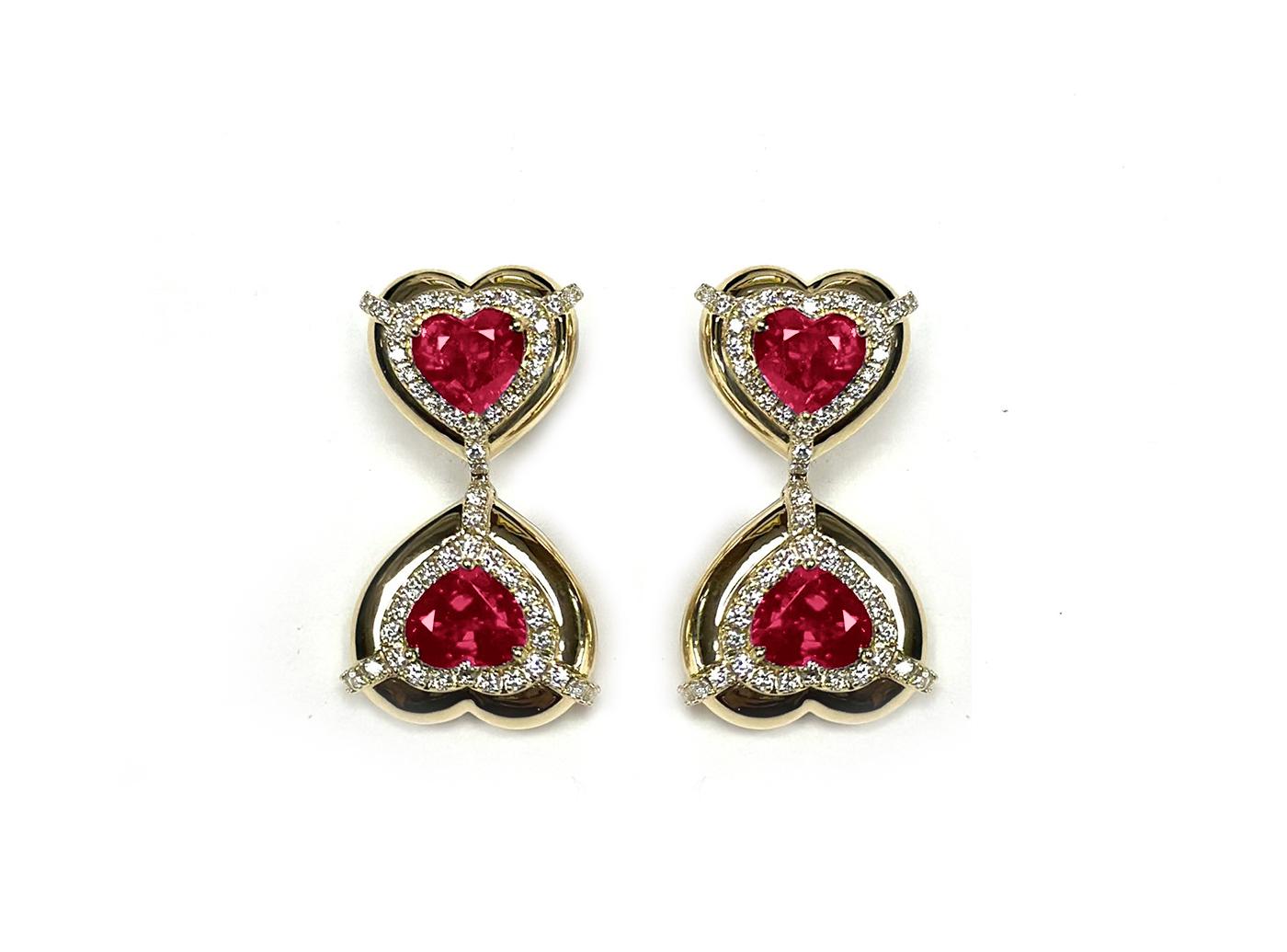 These Double Heart Shape Ruby Earrings with Diamonds in 18K Yellow Gold, part of the 'G-One' Collection, are a stunning display of elegance. These earrings showcase two heart-shaped rubies adorned with diamonds, set in 18K yellow gold. The design is