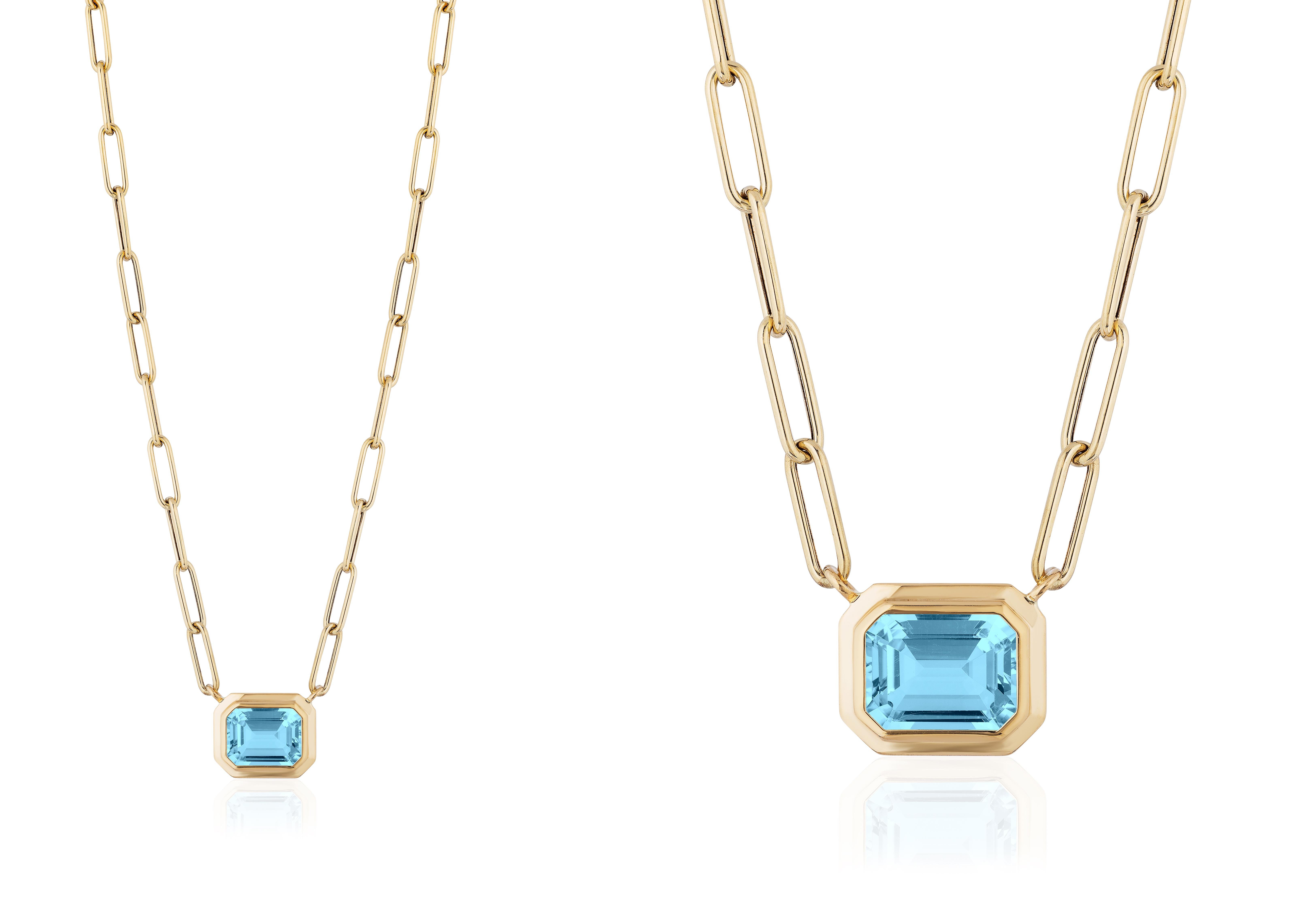 This beautiful East-West Blue Topaz Emerald Cut Bezel Set Pendant in 18K Yellow Gold is from our ‘Manhattan’ Collection. Minimalist lines yet bold structures are what our Manhattan Collection is all about. Our pieces represent the famous skyline and