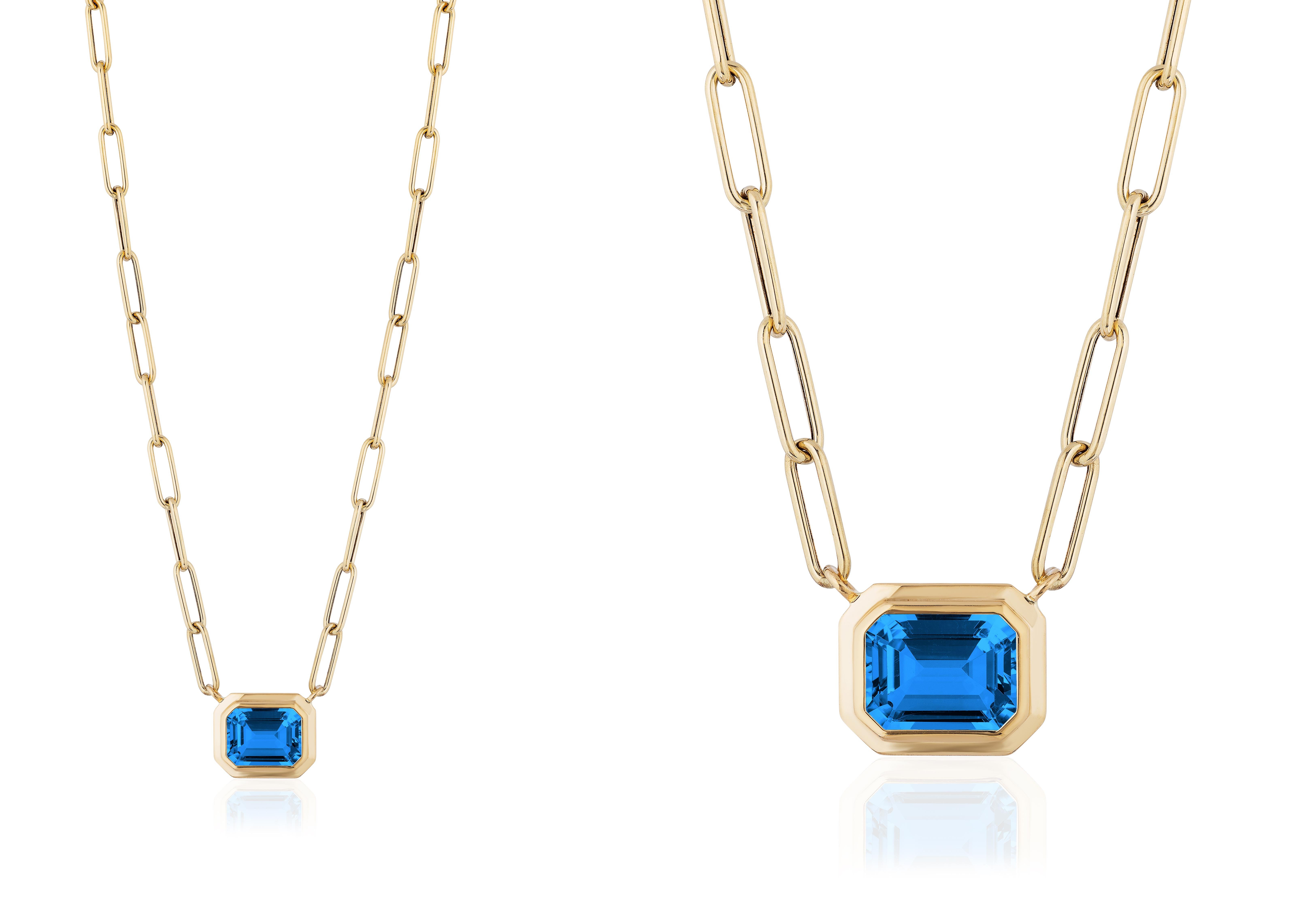 This beautiful East- West London Blue Topaz Emerald Cut Bezel Set Pendant in 18K Yellow Gold is from our ‘Manhattan’ Collection. Minimalist lines yet bold structures are what our Manhattan Collection is all about. Our pieces represent the famous