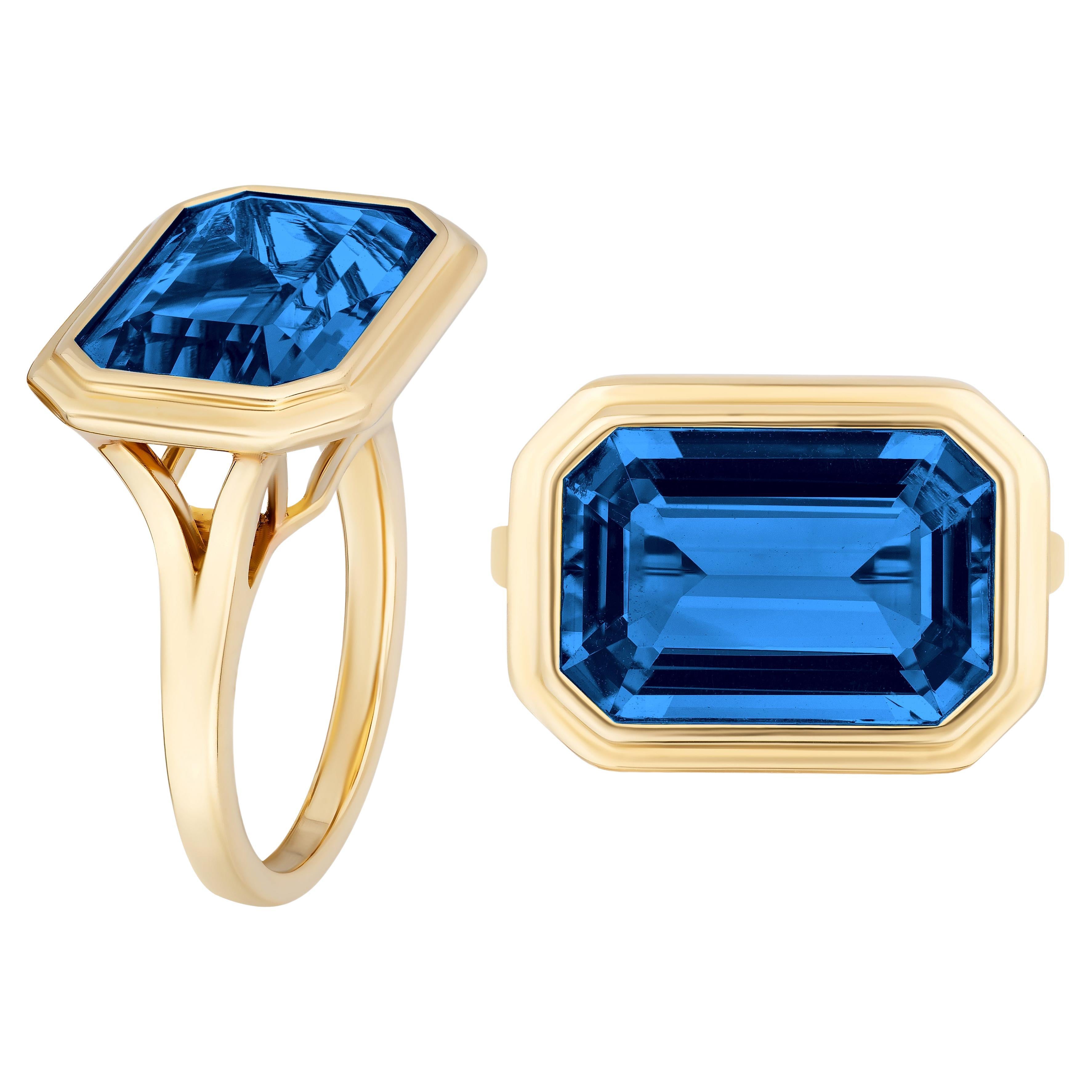East-West London Blue Topaz Emerald Cut Bezel Set Ring For Sale