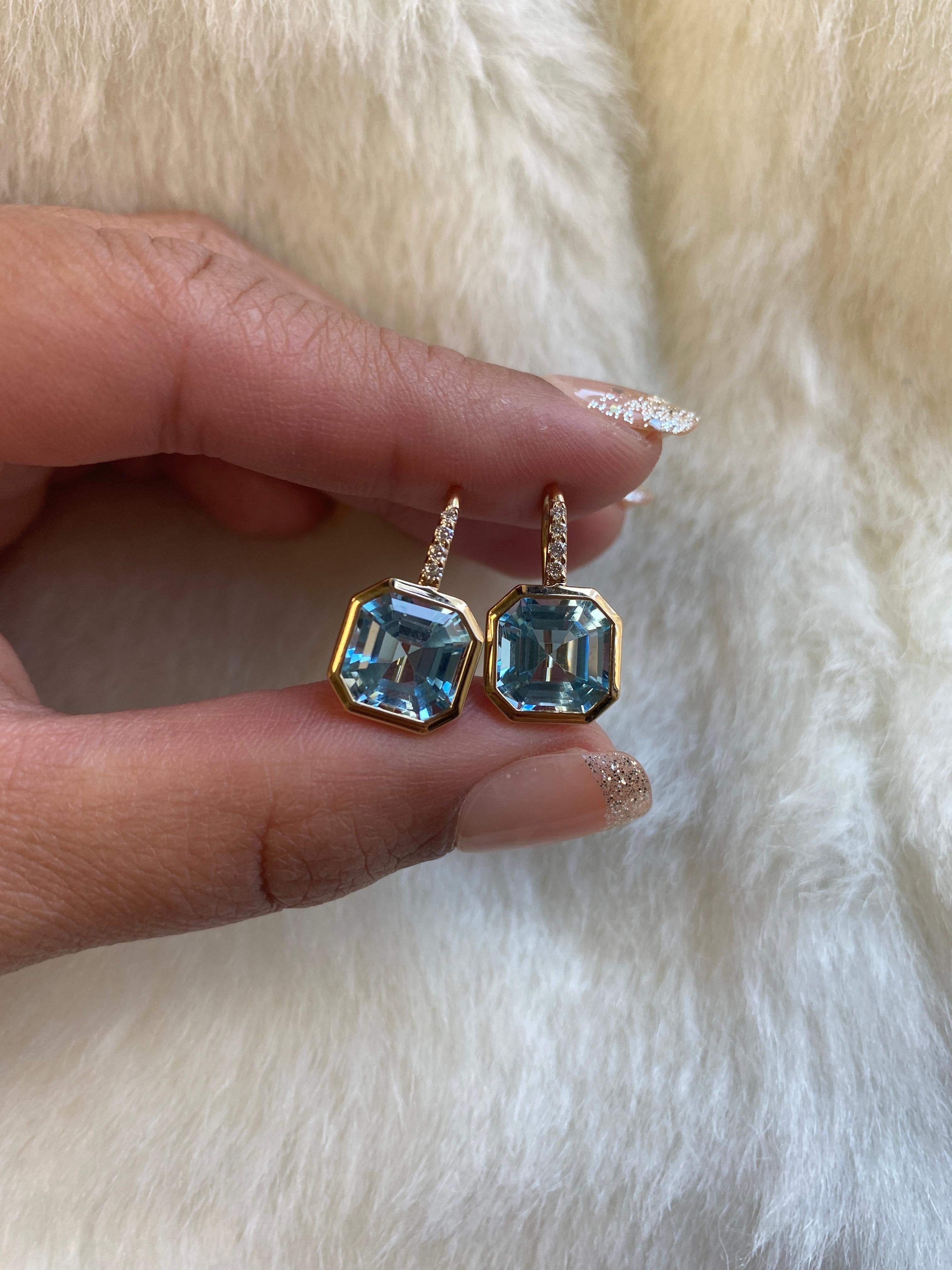 Elevate your style with these exquisite earrings featuring a stunning 9 x 9 mm Asscher-cut Blue Topaz gemstone. Expertly set on a delicate wire of 18K Gold, these earrings are adorned with four dazzling Diamonds, adding a touch of luxury and sparkle