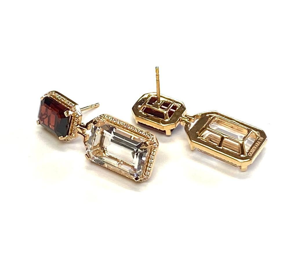 These Rock Crystal & Garnet Emerald Cut Earrings in 18K Yellow Gold with Diamonds are a stunning piece of jewelry from the 'Gossip' Collection. The earrings feature emerald-cut rock crystal and garnet stones, set in 18K yellow gold with sparkling