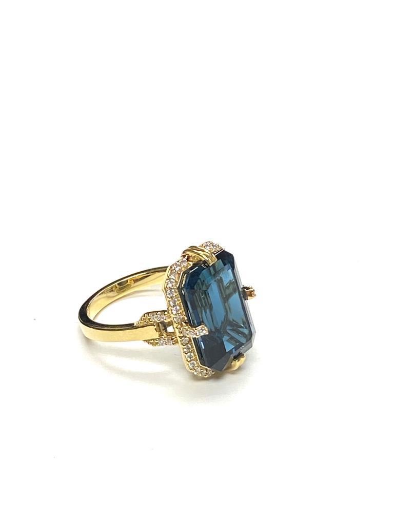 Elegant London Blue Topaz Emerald Cut Ring with Diamonds in 18k Yellow Gold, from 'Gossip' Collection

*Gemstone Size: 15 x 10 mm
*Gemstone Weight: 9.05 Carats

*Carat Approx: 0.28 (Diamond)
*Color: G/H
*Clarity: VS

*Cut: Emerald shape
*Metal: 18k