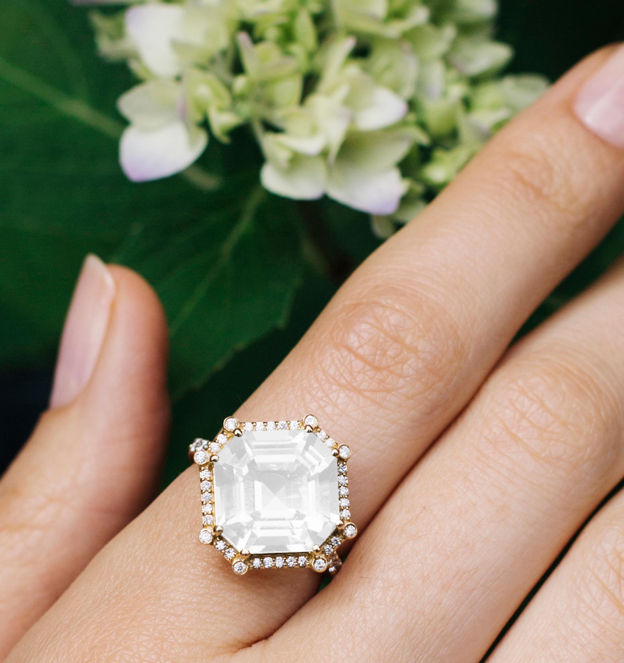 This Moon Quartz Emerald Cut Asscher Ring, is a mesmerizing masterpiece from the 'Gossip' Collection. Crafted in luxurious 18K Yellow Gold, this exquisite ring features a captivating emerald-cut Moon Quartz center stone that radiates an ethereal