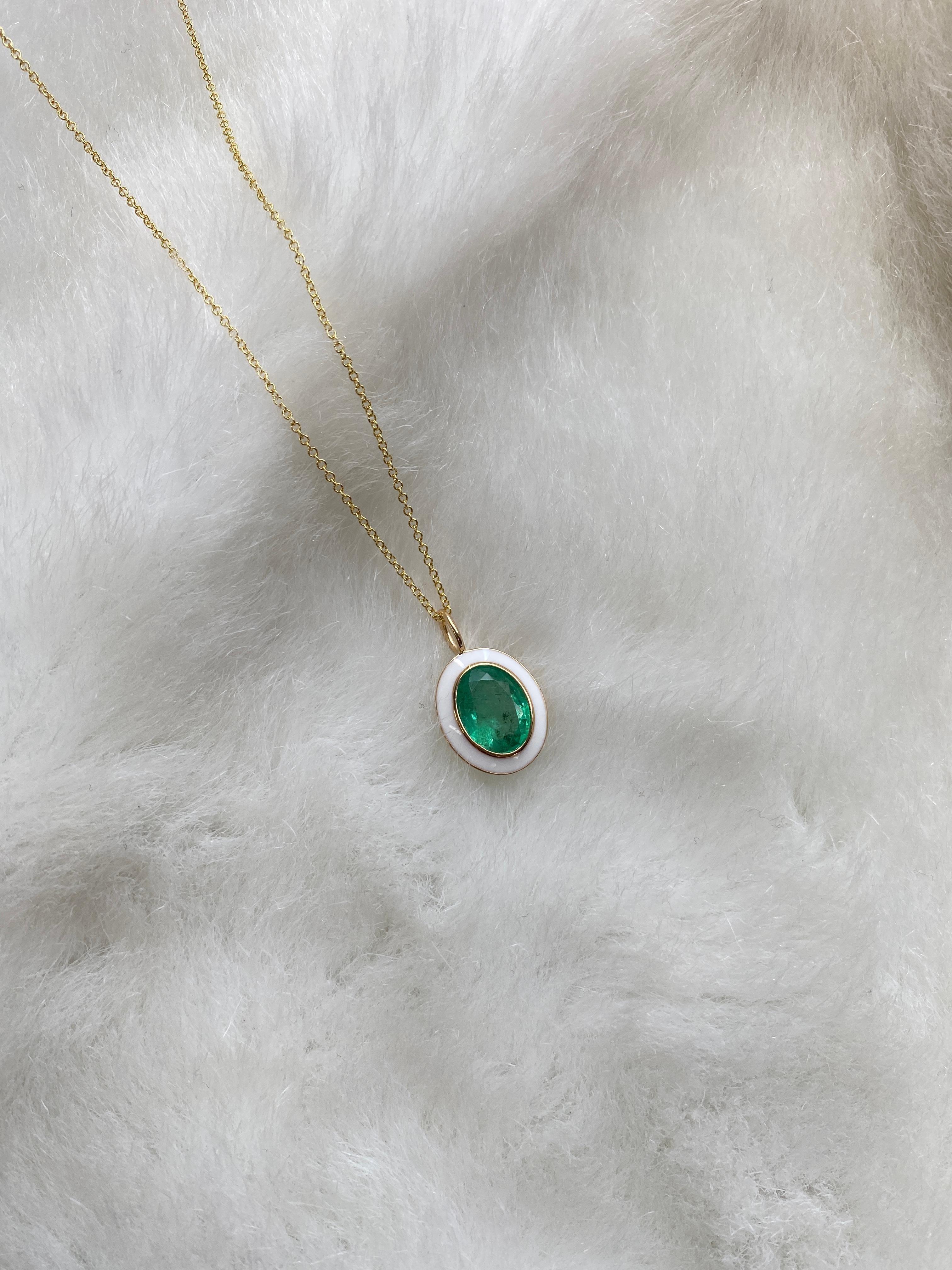 Emerald Oval Pendant with White Enamel in 18K Yellow Gold, from 'Queen' Collection. The combination of enamel, and Emerald represents power, richness and passion of a true Queen. The feeling of luxury is what we’re aiming for, but at a price point