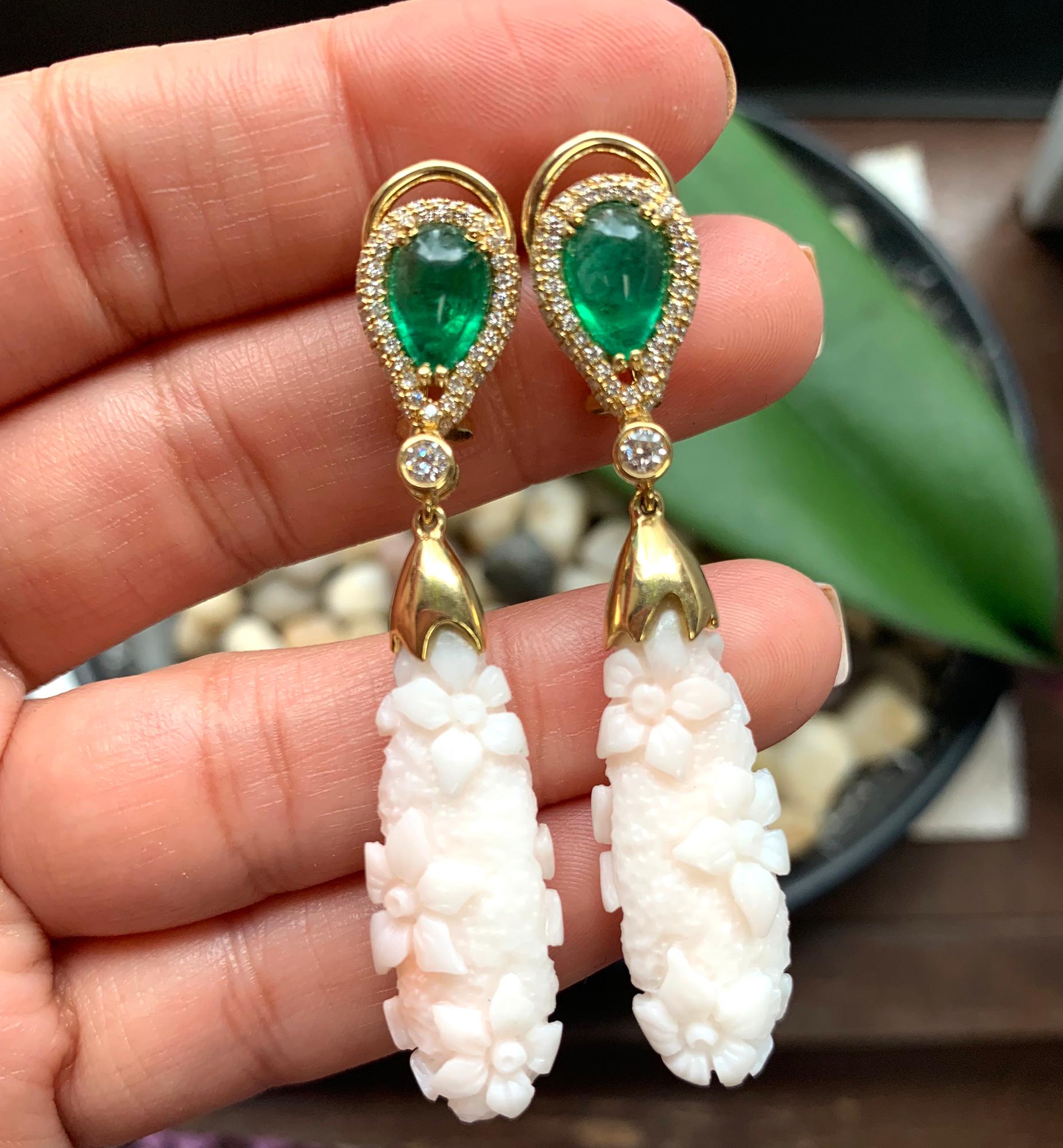 These White Coral Flower Engraved Earrings with Emerald and Diamond Tops in Yellow Gold are a stunning pair of earrings from the 'G-One' collection. The earrings feature engraved flowers in the white coral, which dangle elegantly from a top section