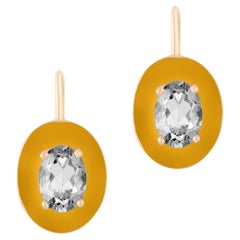 Boucles d'oreilles Goshwara en cristal de roche ovale facetté, avec bordure en émail brun