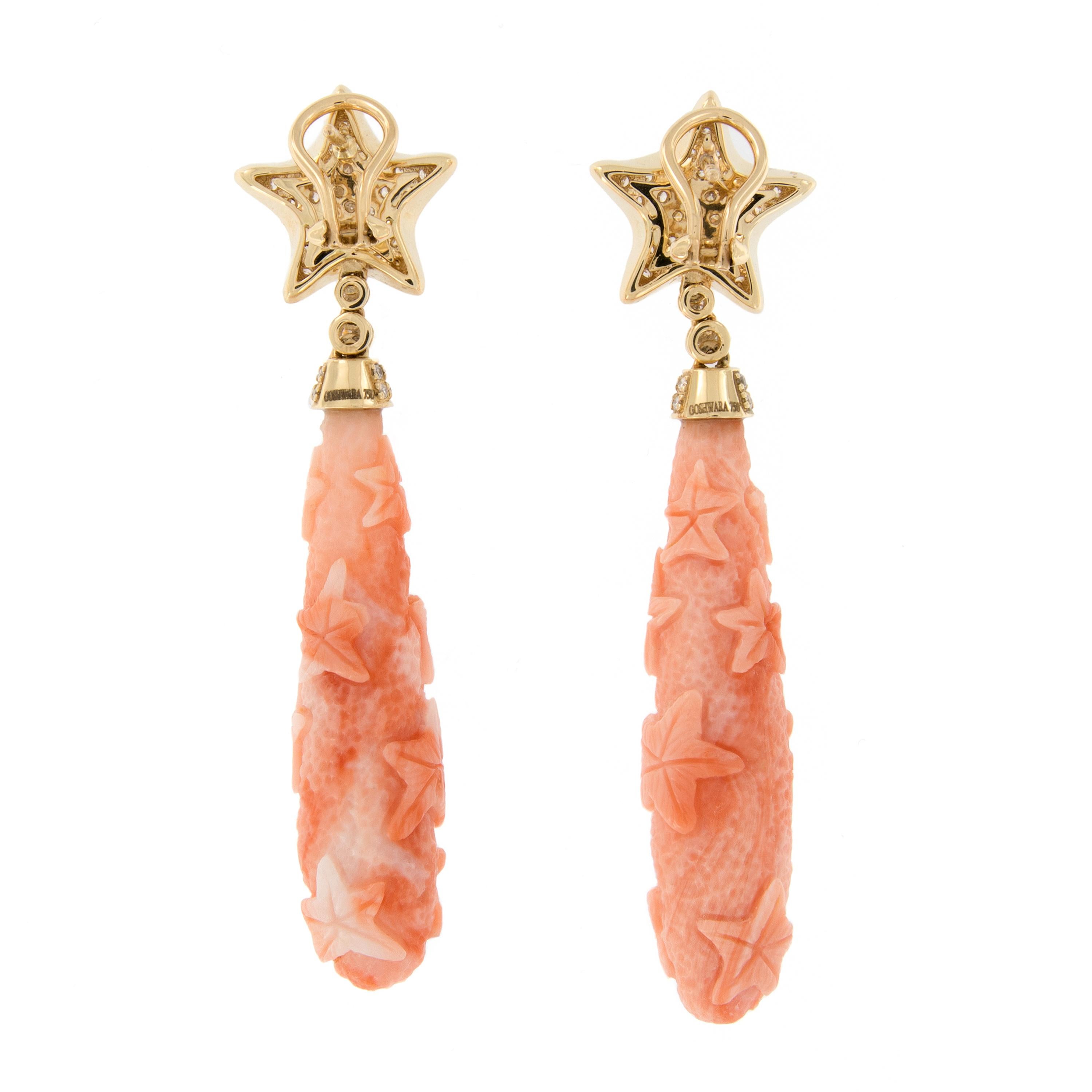 These beautiful earrings are wearable works of art! Earrings feature long coral drops featuring carved stars and drop from a pave set diamond star, crafted in 18k yellow gold. Earrings are from the G-One Collection designed by Goshwara of New York.