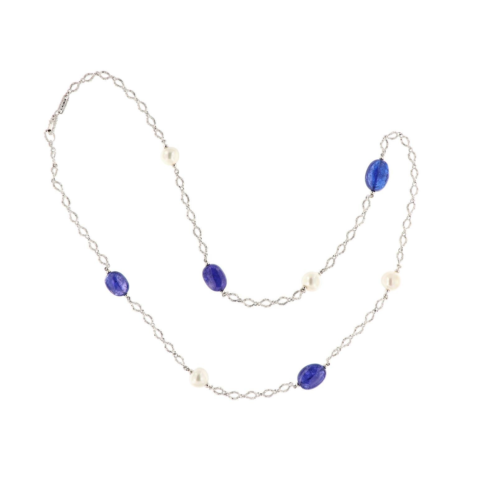 This stunning station necklace features alternating tumbled tanzanite beads and South Sea Pearls on a fancy bright cut 18 karat white gold Italian chain. The necklace is from the G-One Collection designed by Goshwara. The necklace is 36 inches long.
