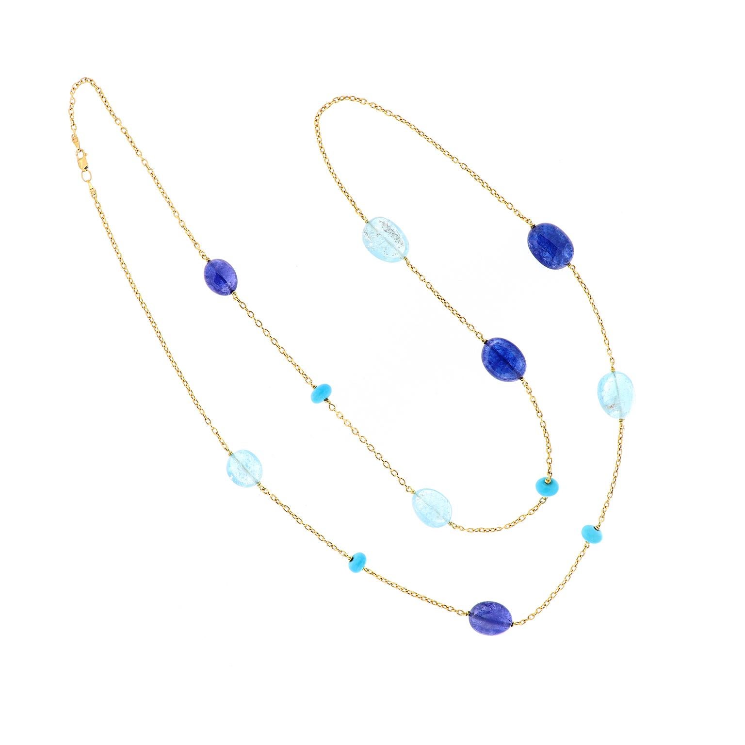 A pretty combination of a blues! The necklace features alternating tumbled tanzanite and blue topaz and turquoise on a 18 karat yellow gold  36 inch chain. The necklace is from the Gossip Collection designed by Goshwara. Weighs 31.8 grams.