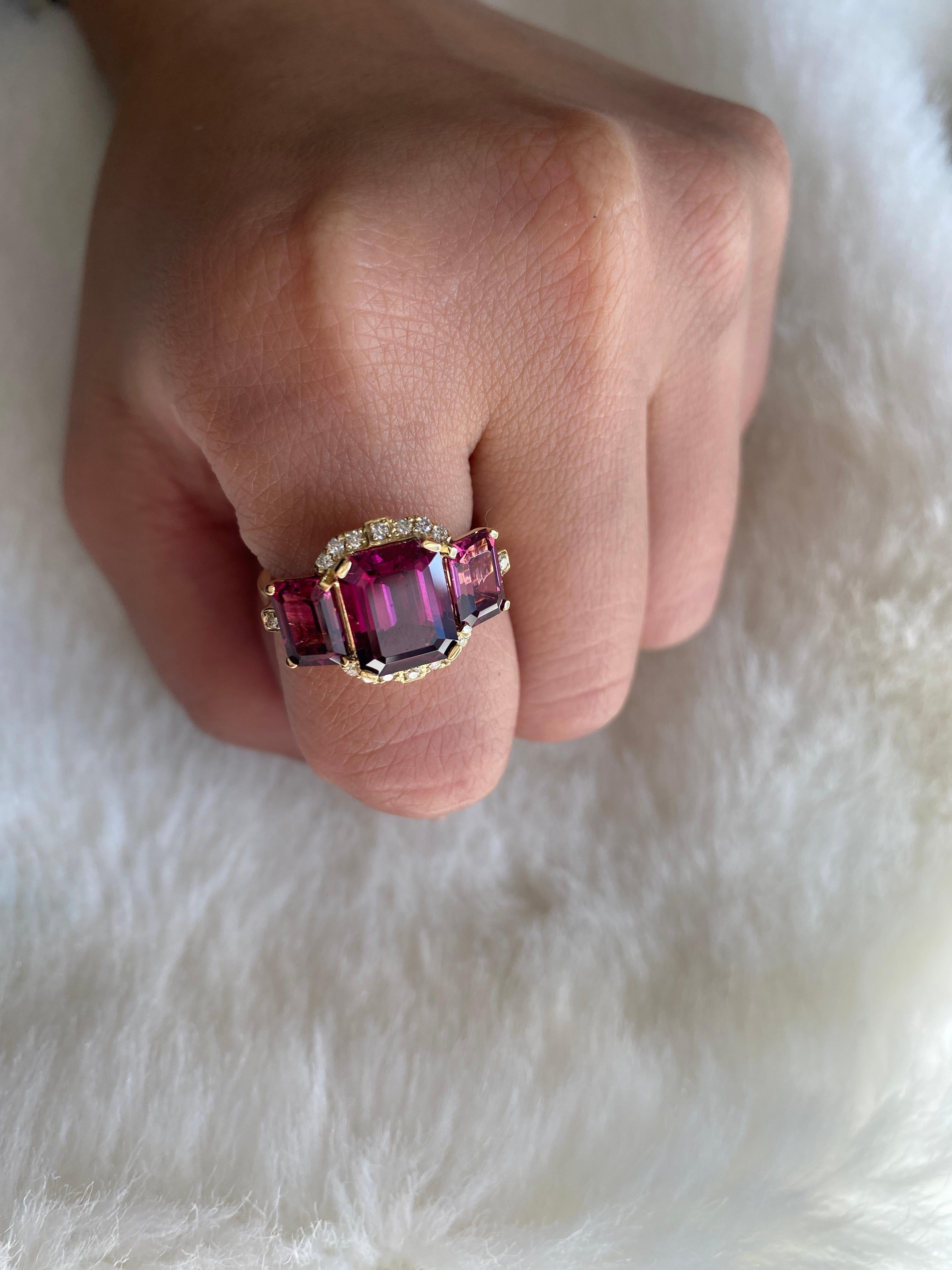 Garnet 3 Stone Emerald Cut Ring with Diamonds set in 18K Yellow Gold. From our popular 'Gossip' Collection, this piece carries a hint of shock value.

* Stone Size: 10 x 8 - 7 x 5 mm
* Gemstone: 100% Earth Mined 
* Approx. gemstone Weight: 5.81