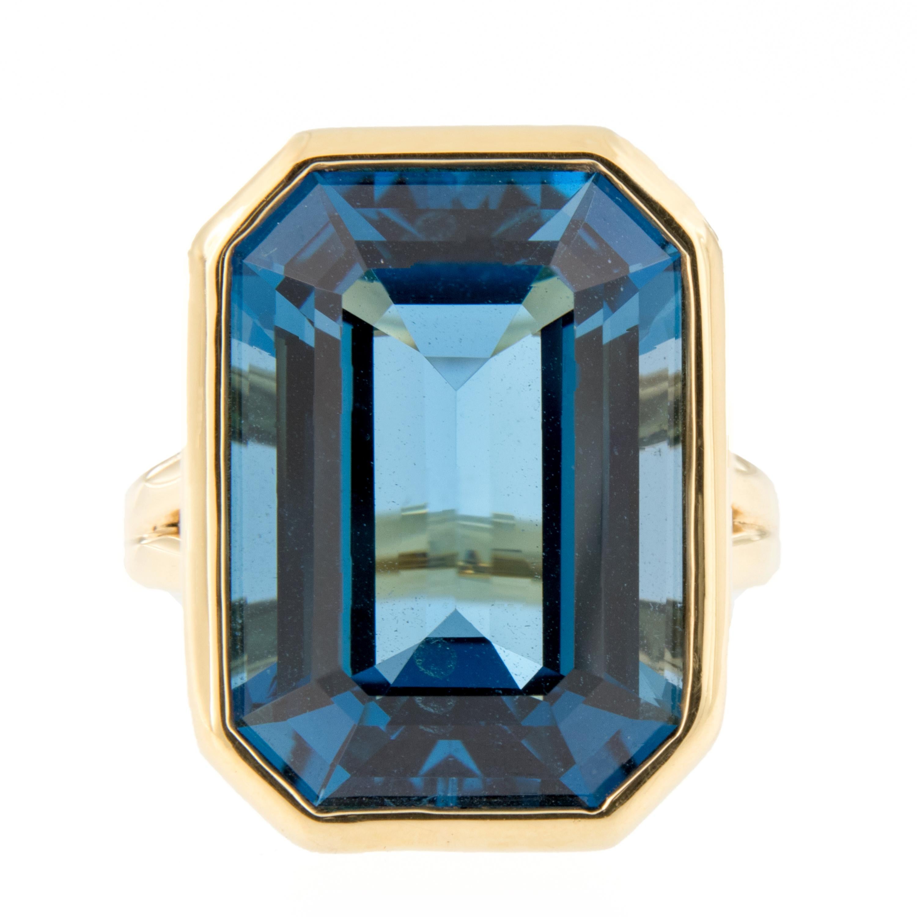 Stunning statement cocktail ring showcases a 24 carat London blue topaz beautifully bezel set in 18k yellow gold. Ring is from the Gossip Collection designed by Goshwara of New York. Ring size 7. Tope of ring measures 17mm x 23mm. Marked