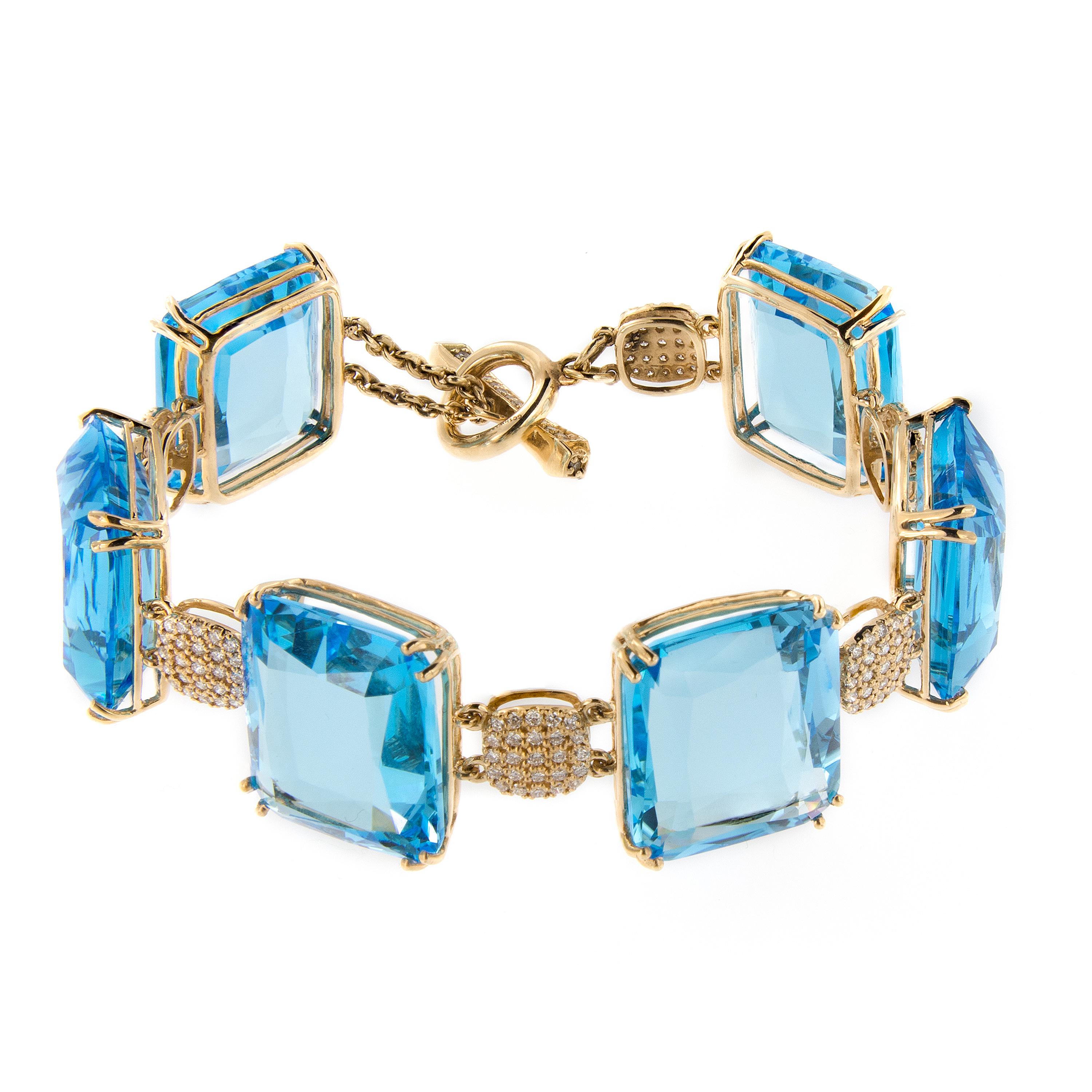 Gossip 18k yellow gold bracelet features blue topaz gems connected diamond set links. Bracelet is from the Gossip Collection designed by Goshwara of New York.  7.25 inches long. Marked Goshwara.

Blue Topaz 148.91 cttw
Diamond 1.74 cttw