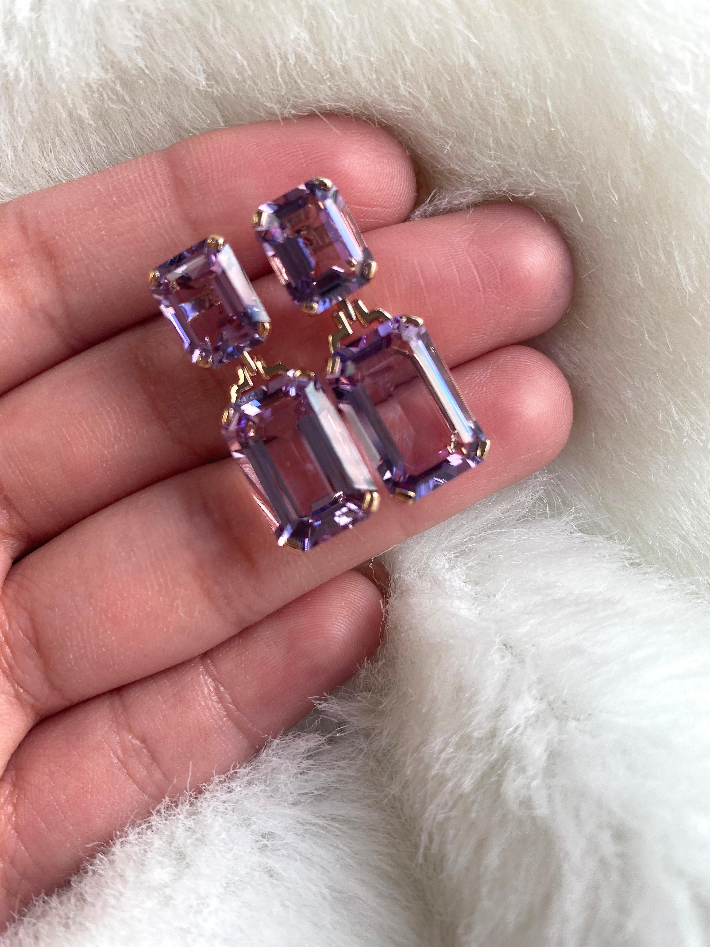 These Lavender Amethyst Double Emerald Cut Earrings in 18K Rose Gold from the 'Gossip' Collection are a stunning and unexpected accessory. With their unique lavender hue and double emerald cut design, these earrings are sure to catch the eye and