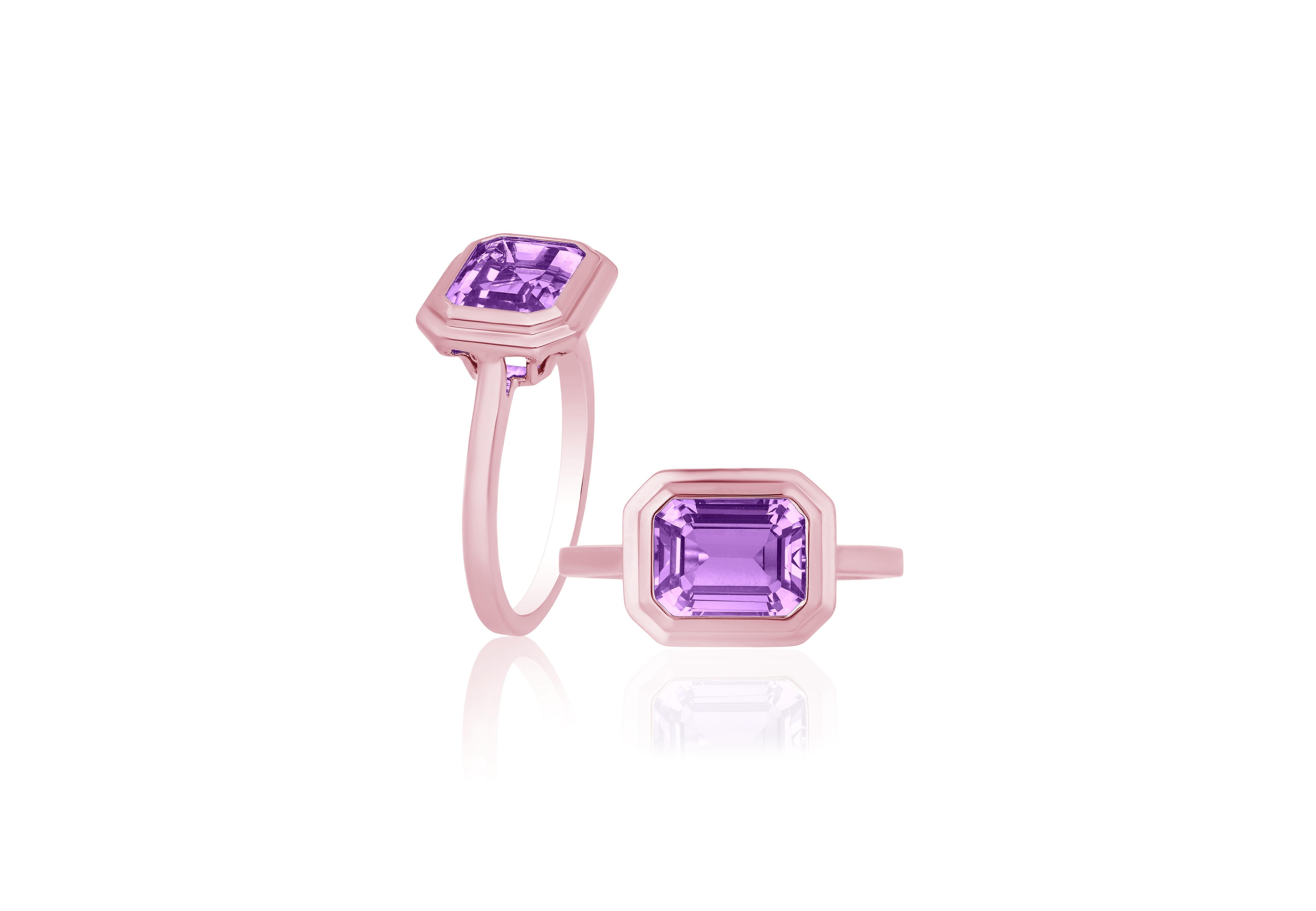 This Lavender Amethyst Emerald Cut Bezel Set Ring in 18K Rose Gold is a sleek piece from the 'Manhattan' Collection. It features a stunning emerald-cut lavender amethyst stone set in a 18K rose gold bezel. This ring embodies modern elegance,
