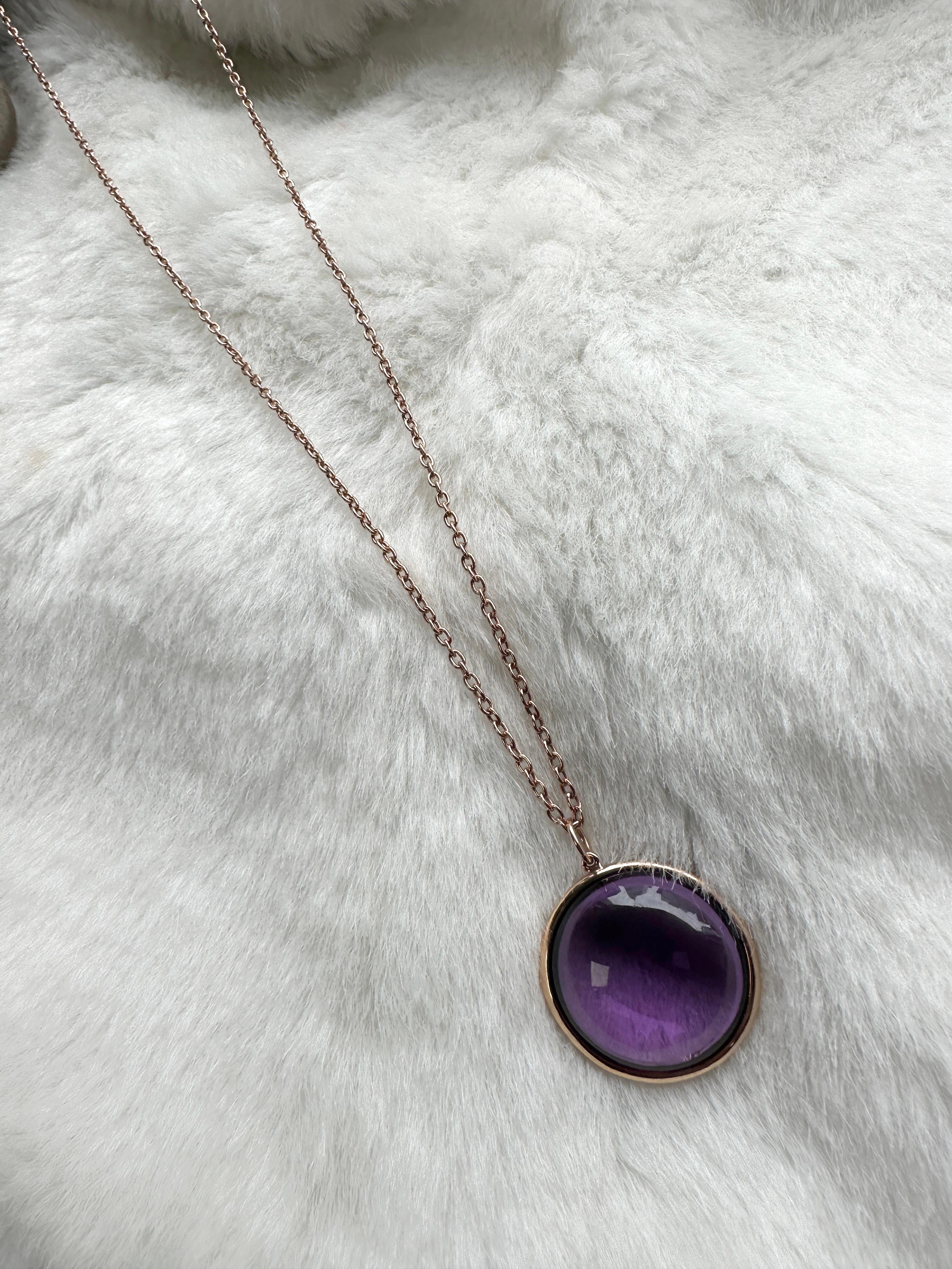 This Lilac Amethyst Round Disc Pendant is a stunning piece of jewelry from the 'Mischief' Collection, crafted in 18K rose gold. The pendant features a round-shaped lilac amethyst gemstone at the center. The lilac amethyst has a gorgeous light purple