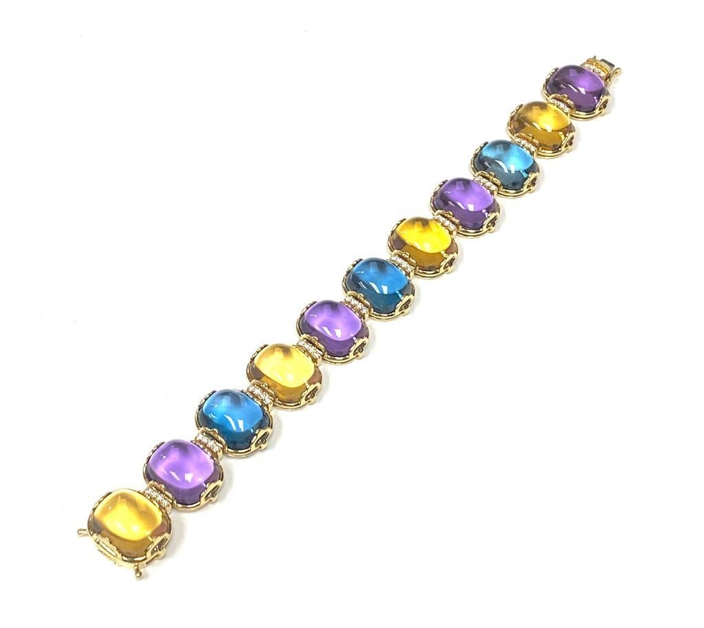 This London Blue Topaz, Citrine and Amethyst Cushion Bracelet is a stunning piece of jewelry from the 'Rock 'N Roll' Collection. Crafted in 18K Yellow Gold, it features a combination of vibrant blue, yellow and purple gemstones in cushion-cut