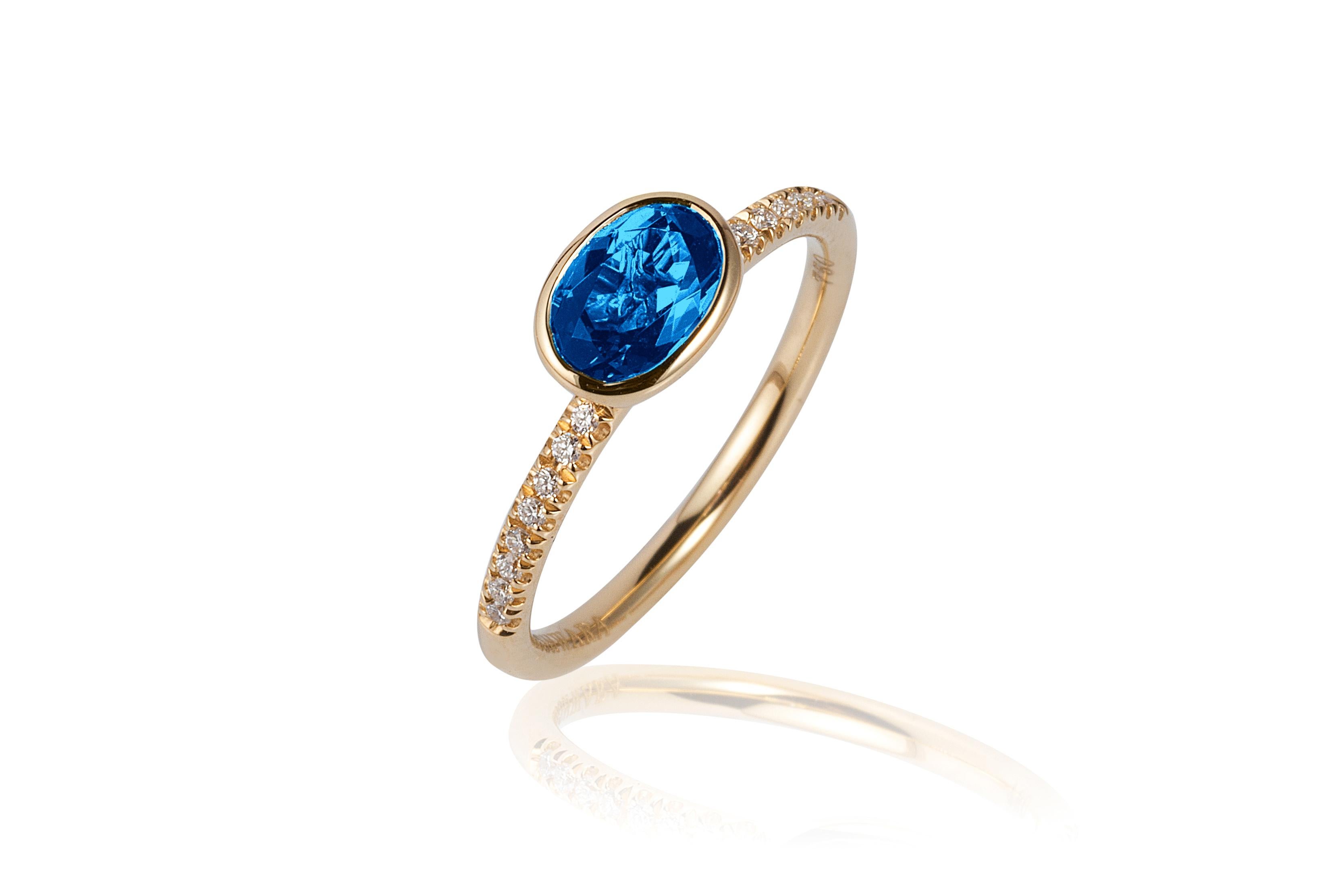 London Blue Topaz Faceted Oval Ring with Diamonds in 18K Yellow Gold, from 'Gossip' Collection
 
 Stone size: 7 x 5 mm
 
 Gemstone Approx. Wt: Blue Topaz- 0.93 Carats
 
 Diamonds: G-H / VS, Approx. Wt: 0.08 Carats