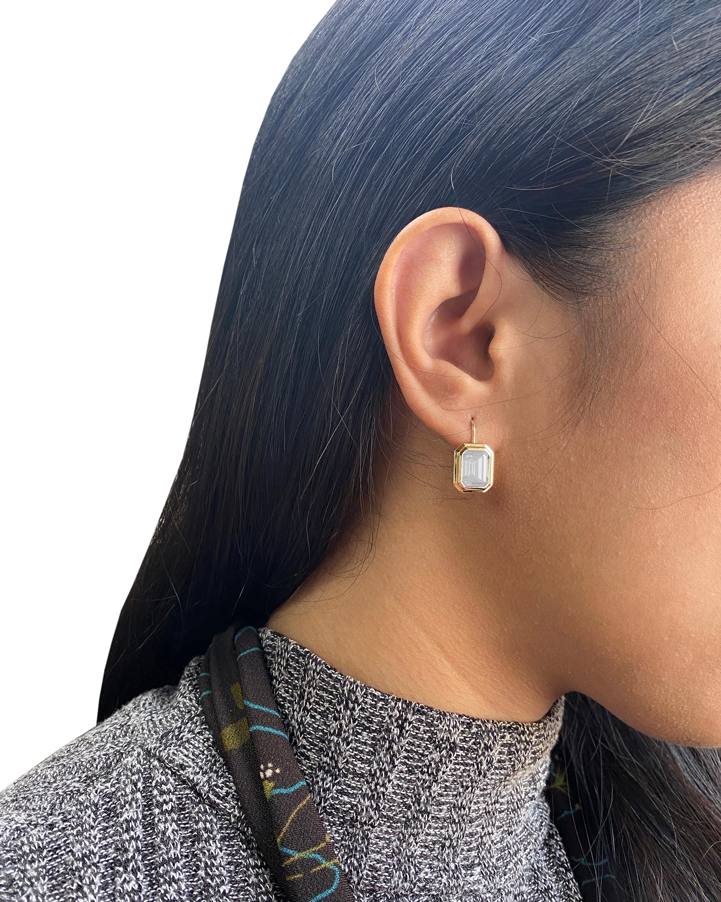 These Moon Quartz Emerald Cut Bezel Set Earrings on Wire in 18K Yellow Gold from the 'Manhattan Collection are a stunning and sophisticated jewelry piece. These earrings feature exquisite Moon Quartz gemstones with an elegant emerald cut, cradled in