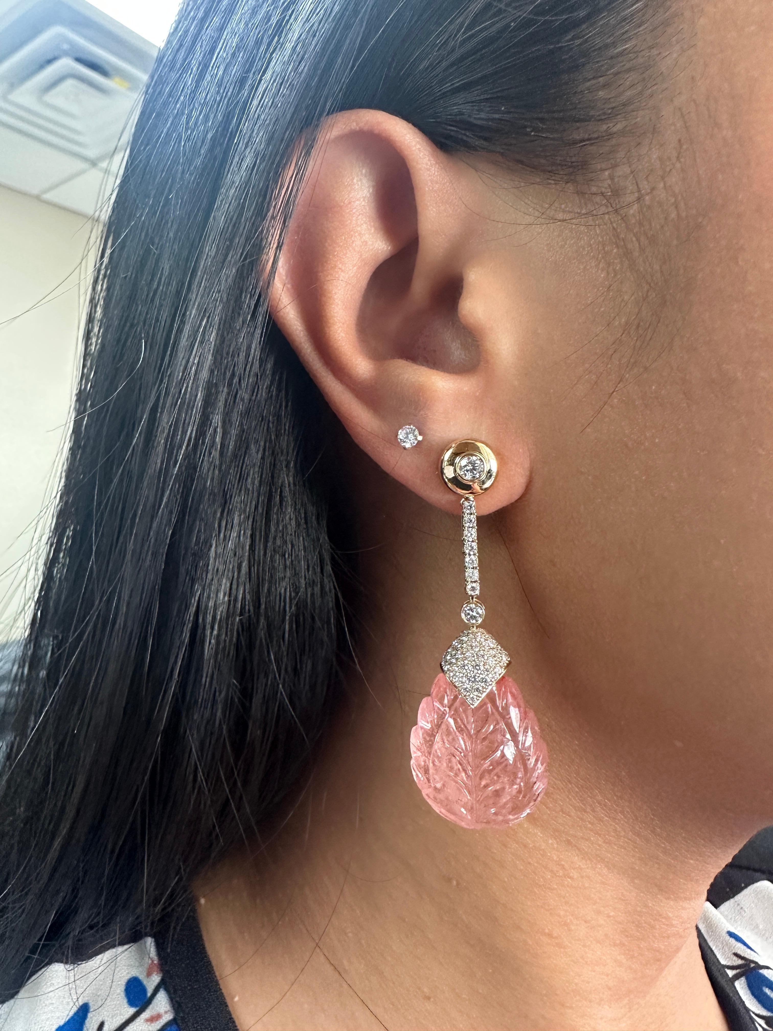 The Morganite Carved Drop Earrings with Diamond Cap in 18K Yellow Gold are exquisite pieces of jewelry from the 'G-One' Collection. These earrings feature stunning morganite gemstones that have been expertly carved into elegant drop shapes. The