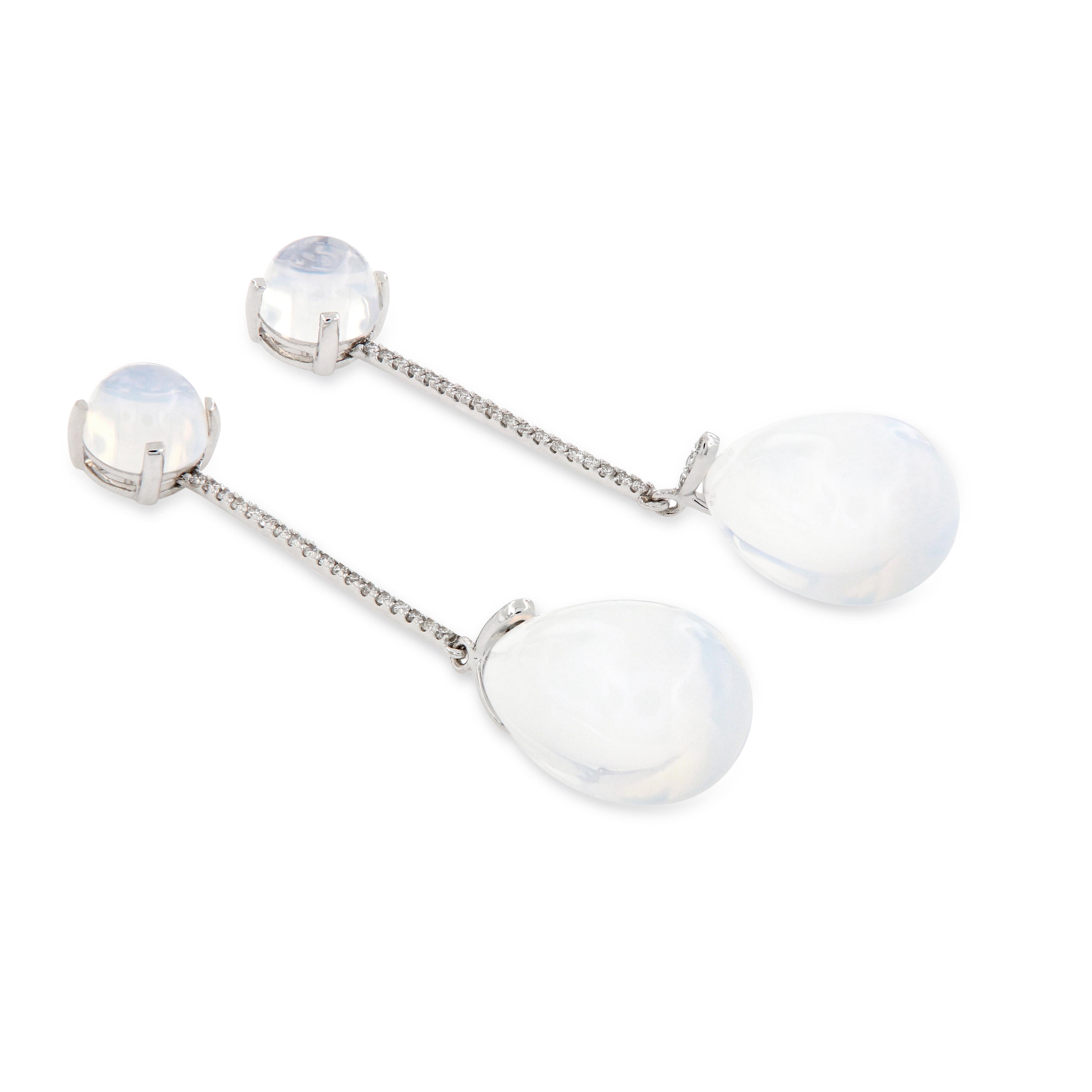 Eye-catching earrings feature moon quartz drops accented with diamonds and crafted in 18k white gold. Earrings are from the Naughty  Collection designed by Goshwara. Earrings are 53 mm long. Moon quartz drop is 19 mm x 12 mm. Weigh 12 grams. Marked