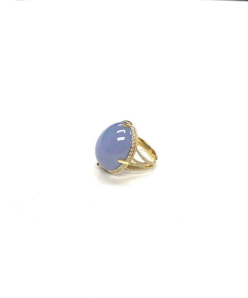 The Blue Chalcedony Cabochon Ring with Diamonds in 18k Yellow Gold is a stunning piece of jewelry from the 'Limited Edition' Collection. The ring features a beautiful blue chalcedony cabochon that is expertly cut and polished to enhance its natural