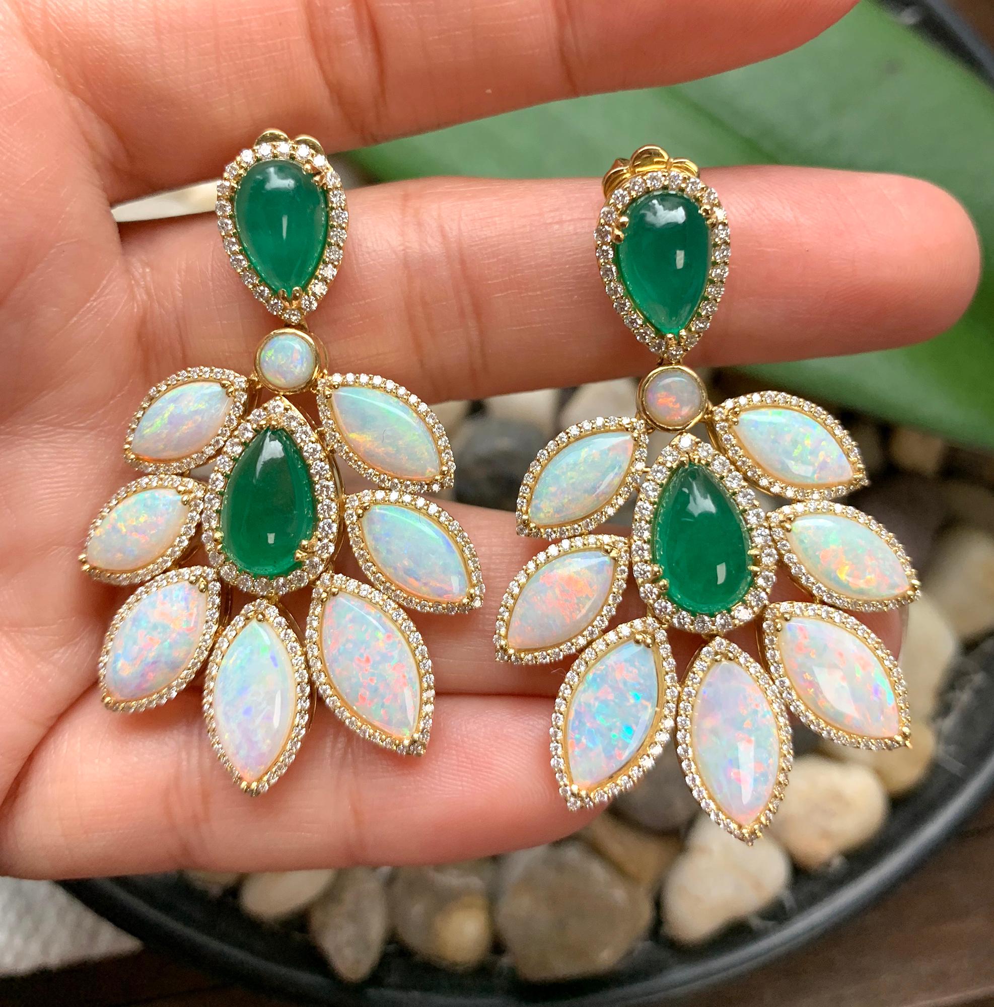These Emerald Pear Shape Cabs and Opal Marquise Earrings in 18K Yellow Gold with Diamonds are a stunning pair of earrings from the 'G-One' Collection. The earrings feature pear-shaped cabochon-cut emeralds and marquise-cut opals, both set in 18K