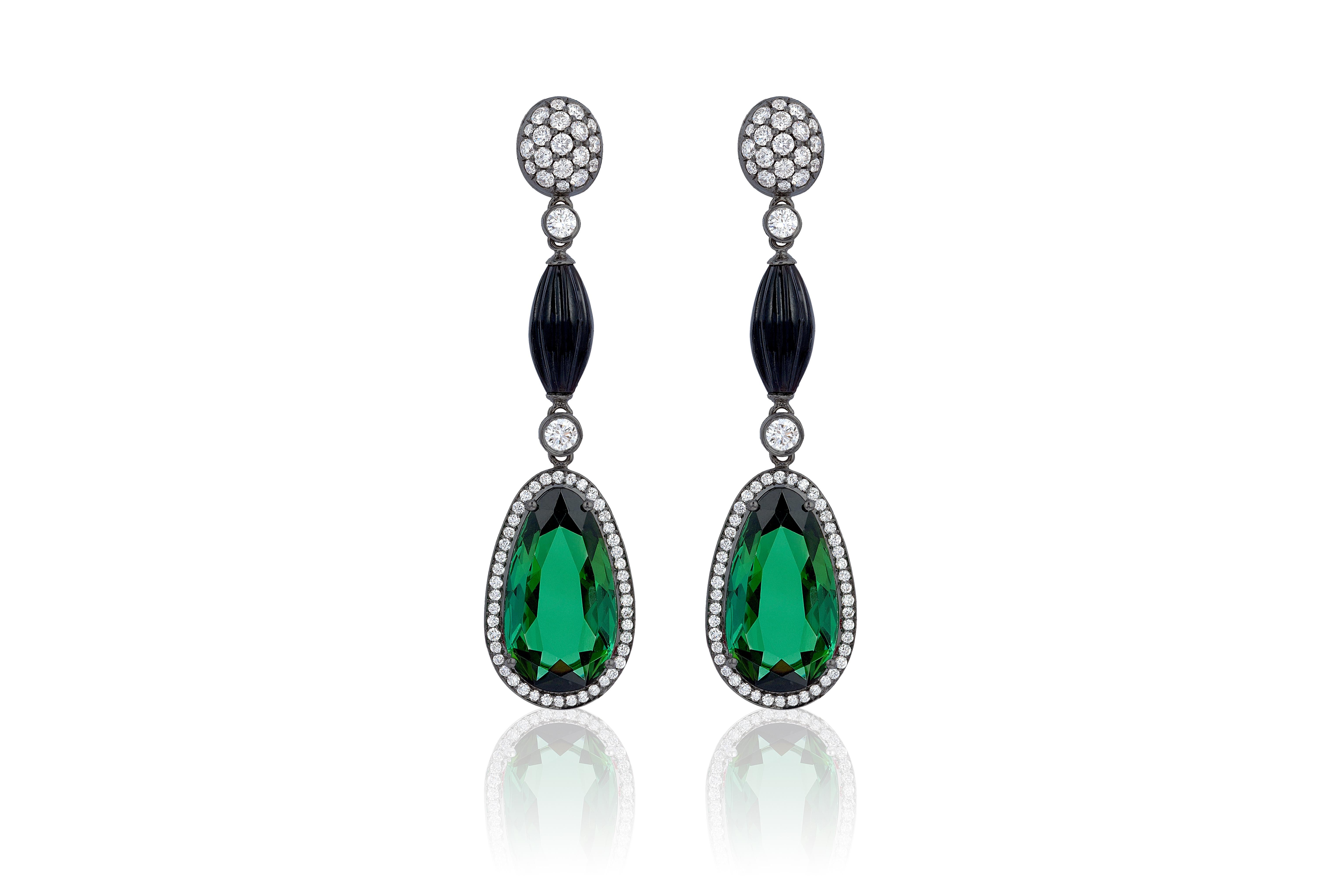 These Green Tourmaline Pear Shape with Onyx Briolette Long Bead Earrings and Diamond Oval Motif in 18K White Gold are exquisite earrings from the 'G-One' Collection. These earrings are designed to add a touch of elegance and luxury to your special