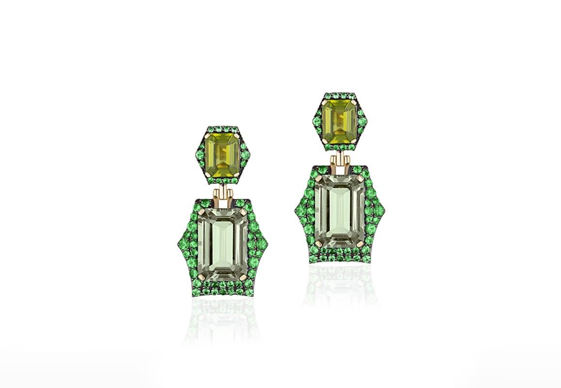 These Peridot & Prasiolite Emerald Cut Earrings with Tsavorites in 18K Yellow Gold & Black Rhodium are a stunning piece of jewelry from the 'Rain Forest' Collection. The earrings feature a beautifully cut emerald-shaped peridot and prasiolite