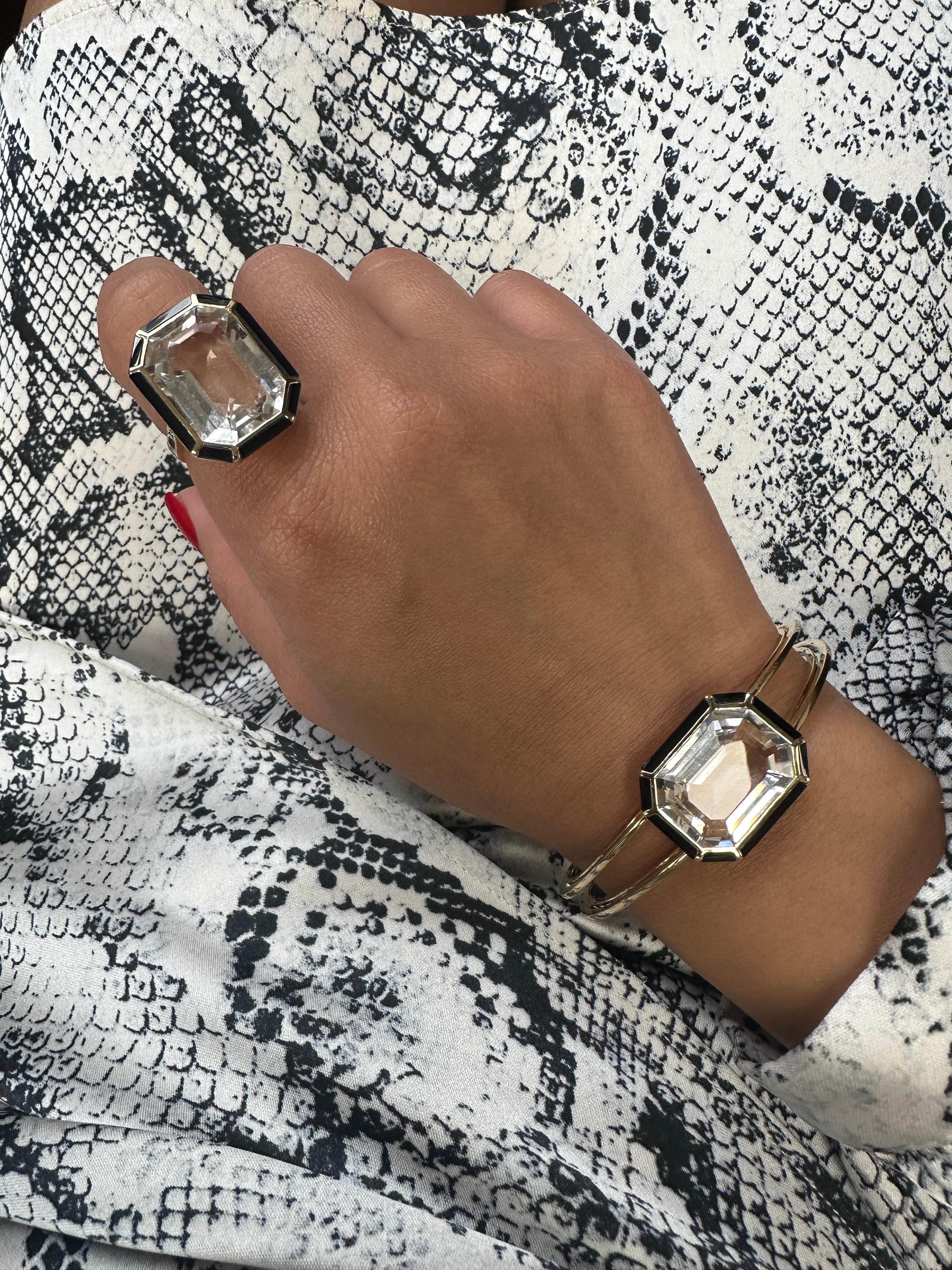 The Rock Crystal Onyx Emerald Cut Cuff from the 'Mélange' Collection is a stunning piece of jewelry in 18K yellow gold. It features an exquisite emerald-cut rock crystal with and onyx border. This cuff blends contrasting elements to create a
