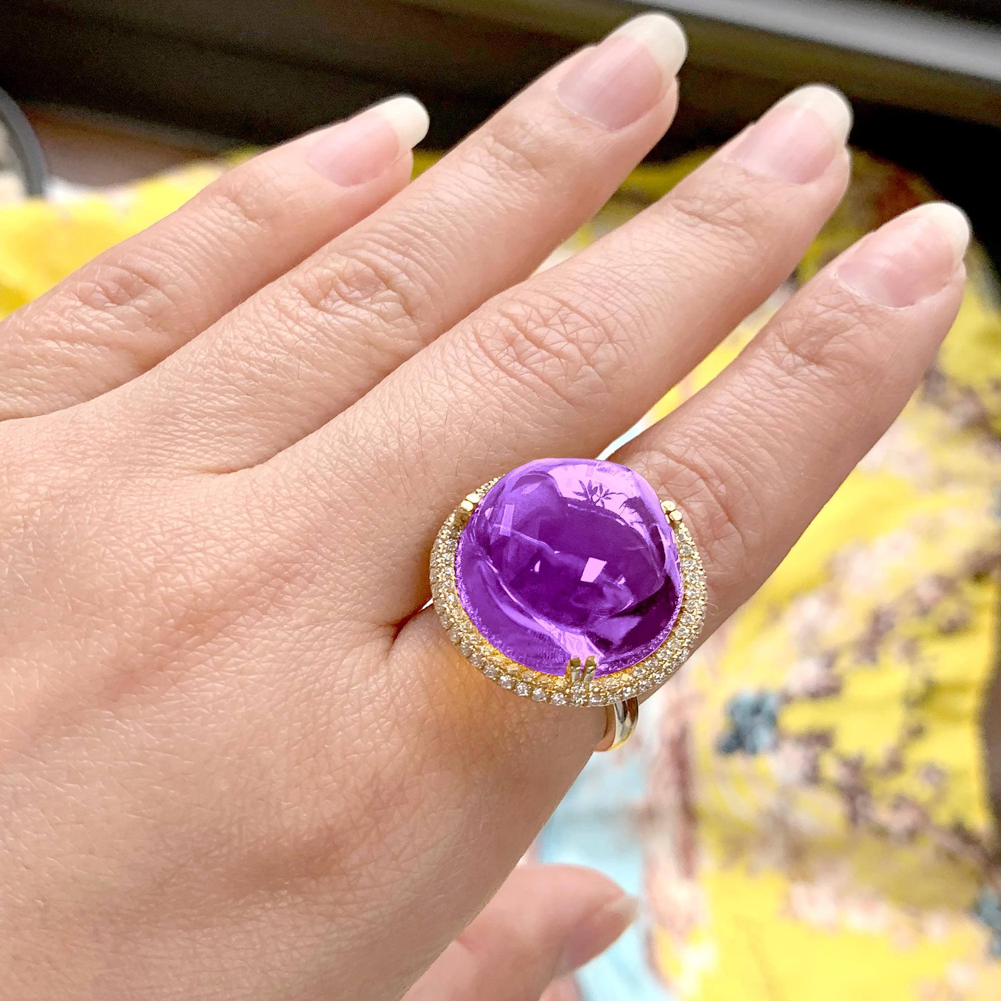 The Amethyst Uneven Round Cabochon Ring in 18K Yellow Gold with Diamonds is a stunning piece from the 'Rock 'N Roll' Collection. The ring features a vibrant amethyst stone that is cut in an uneven round cabochon shape, adding a unique and edgy touch