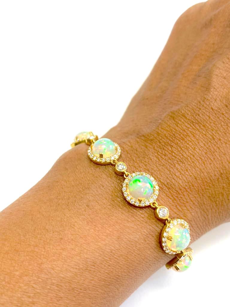 Round Opal Single Row Bracelet with Diamonds in 18K Yellow Gold, from 'G-One' Collection

Stone Size: 10 mm  

Length: 6 3/4'' (Size can be adapted as per request)

Approx. Stone Wt: 22.22 Carats (Opal) 

Diamonds: G-H / VS, Approx. Wt: 2.86 Carats 