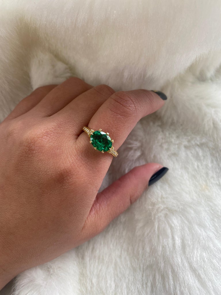 Beautiful Small Oval Emerald Ring with Diamonds in 18K Yellow Gold, from 'G-One' Collection.

* Gemstone size: 9 x 8 mm 
* Gemstone: 100% Earth Mined 
* Approx. gemstone Weight: 1.72 Carats (Emerald)

* 100% Natural Earth-Mined Diamonds
* Carat: