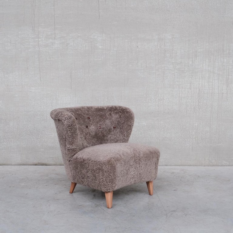 A scarce lounge chair by Gösta Jonsson. 

Professionally re-upholstered in sheepskin shearling. 

Sweden, c1940s. 

Open splayed wings provide comfort to match its style. 

A flexible chair that sits well in a lounge or a bedroom.