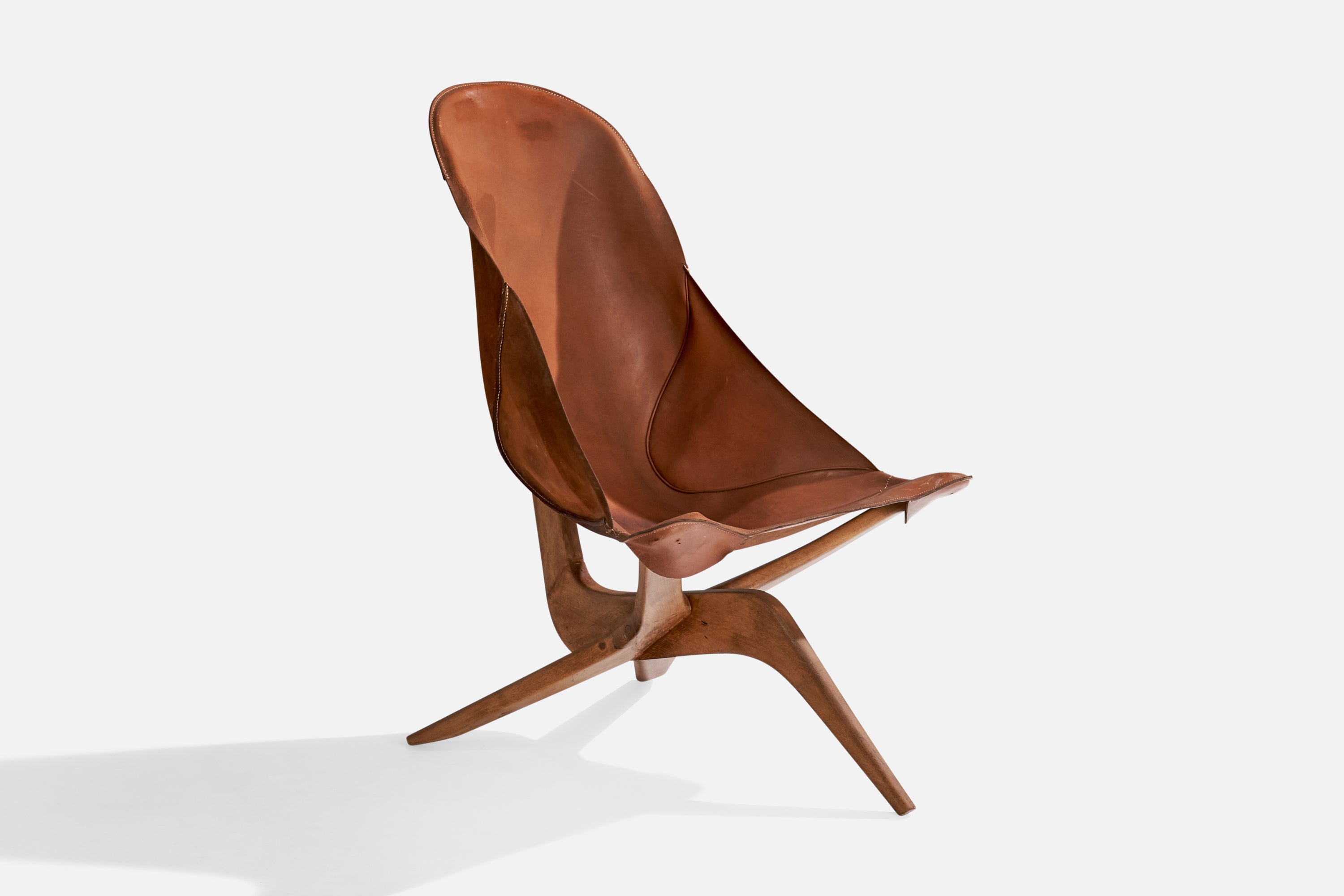 A brown leather and beech lounge chair designed and produced by Gösta Westerbergs, Sweden, 1954.

Dimensions: 39” H x 27.375” W x 37.25” D

Seat height: 16.25”