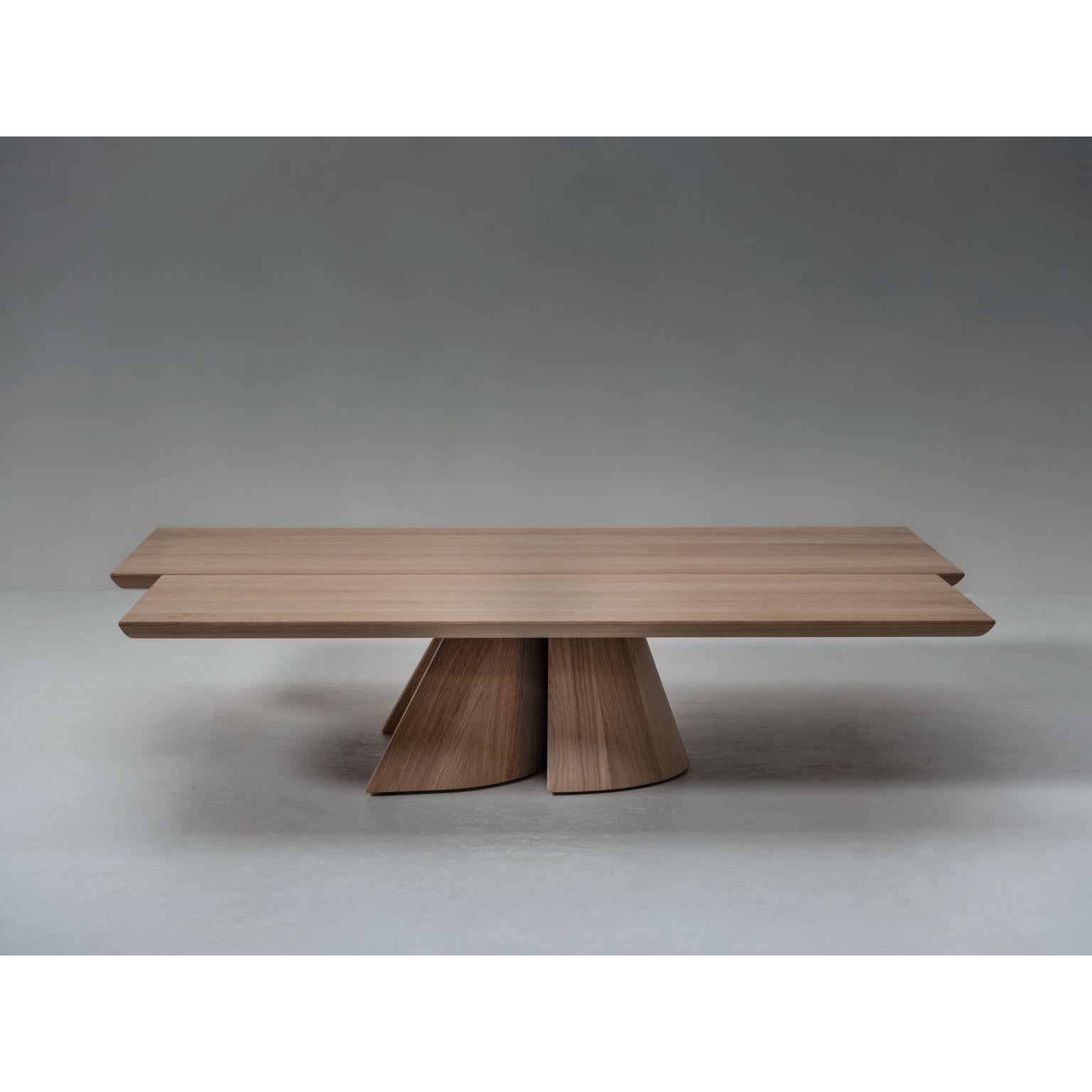 Got Coffee Table by Van Rossum
Dimensions: D150 x W120 x H33cm
Materials: Oak Nude

A solid coffee table featuring a delicately crafted tabletop with a semi-oval base, supported by a striking base of asymmetrical crescent legs that interlock in a