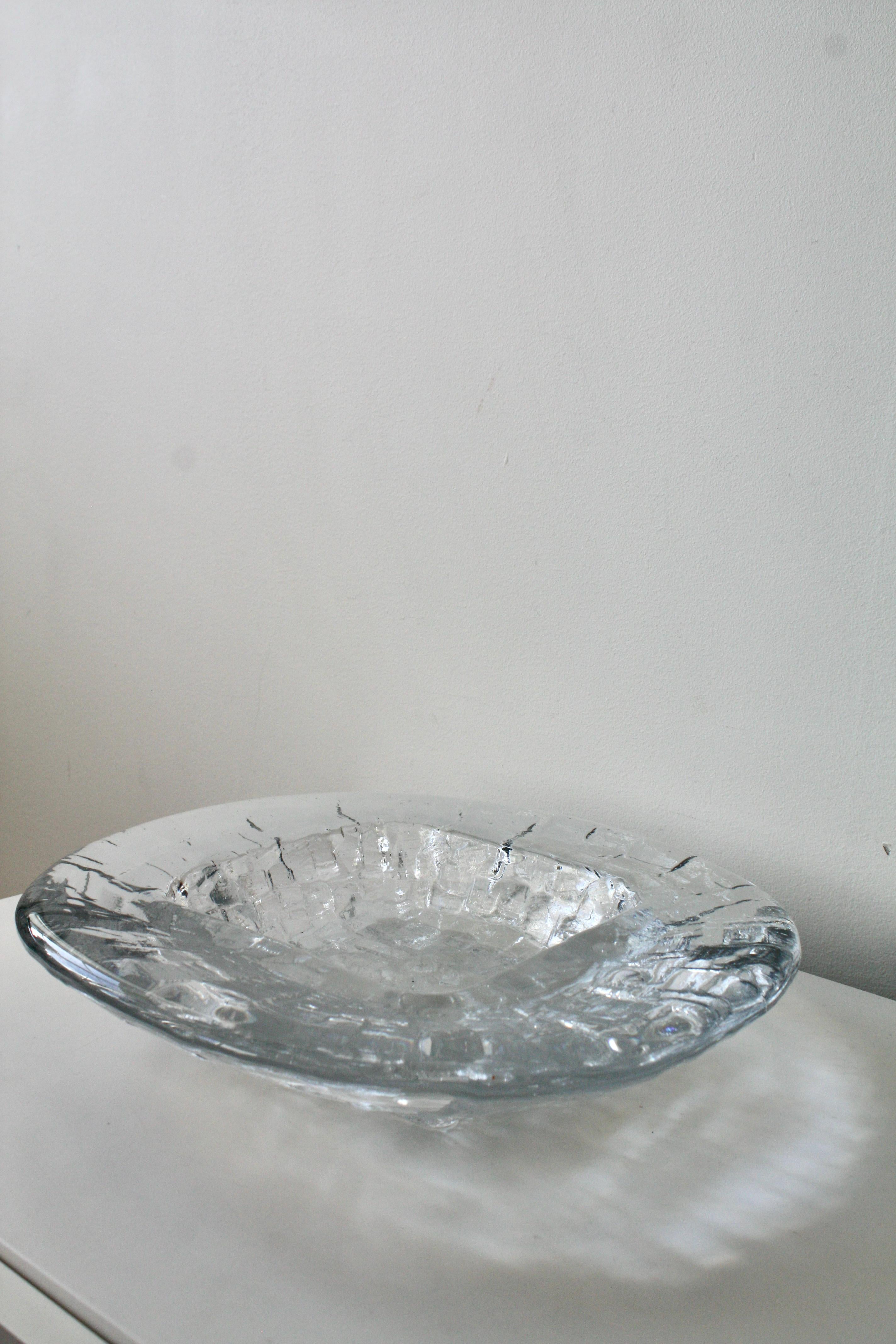 A remarkable example of 1960s Swedish glass design, this Göte Augustsson “Demant” Brutalist glass bowl is both an art piece and a functional object. Crafted in thick, heavy crystal glass, this work has a powerful physical presence. Its massive