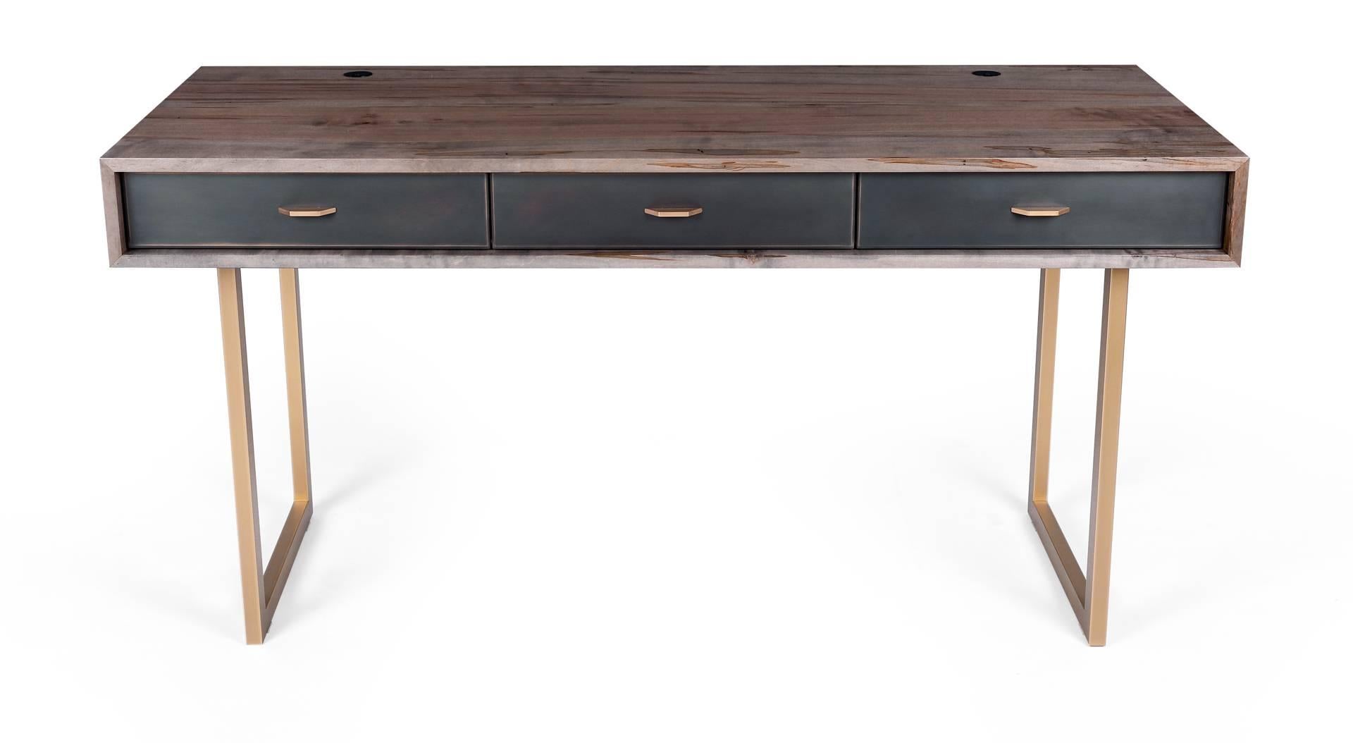 The harmonious mix of materials enhances the beauty of this Gotham desk. The desk features rich oxidized Ambrosia maple wood, a bronze frame, three blackened bronze encased in epoxy resin drawers with black leather lining and hand-sculpted bronze