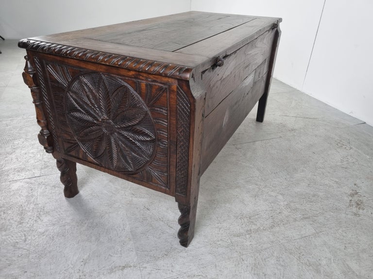 Antique 19th century blanket chest with lots of detailed wood carvings all around.

The carvings also depict two persons.

Twited legs and gothical colums.

The chest can be used for all sorts of storage and is a great decorative piece.

The