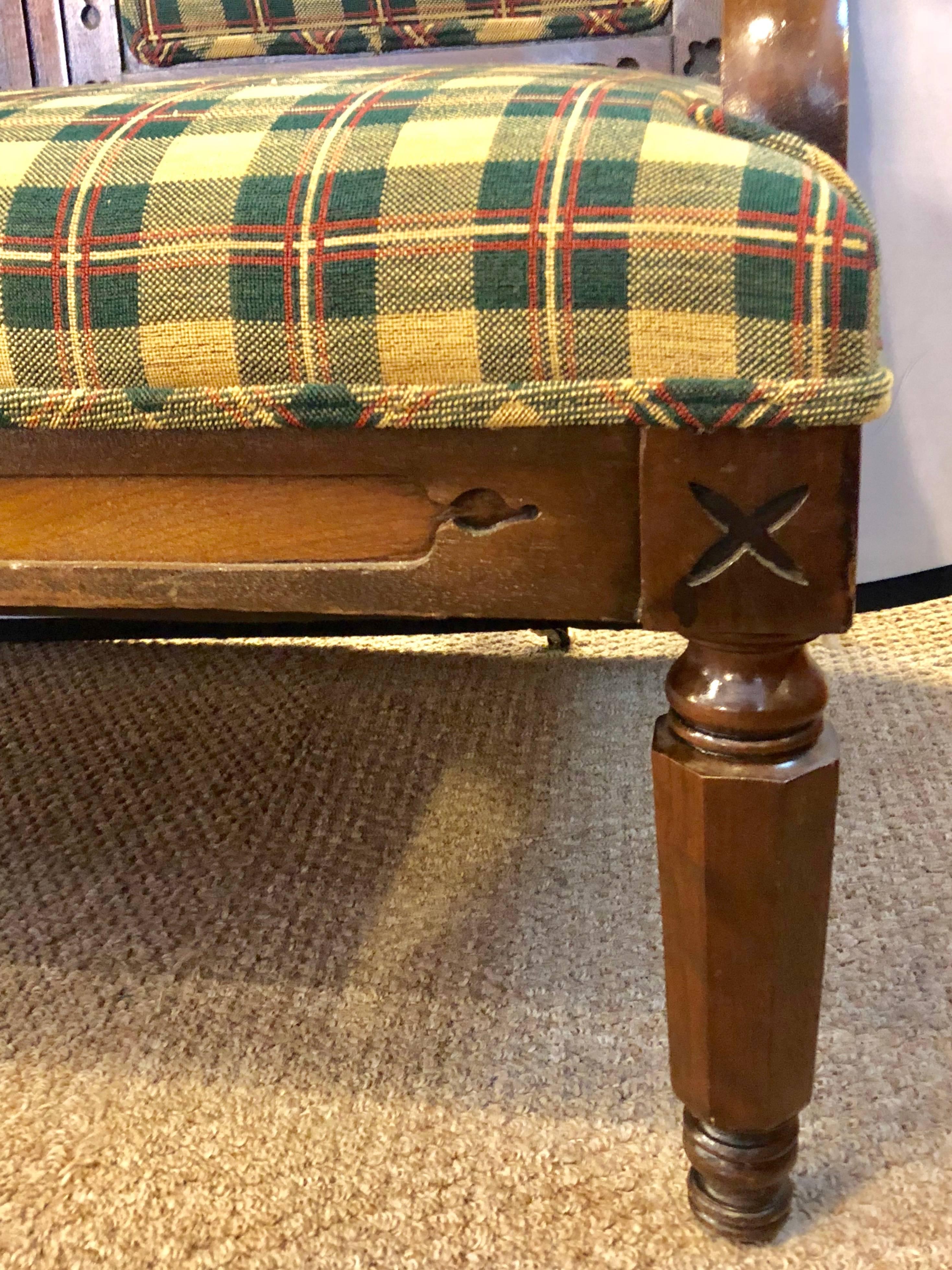 A Gothic 19th century sofa in an Irish plaid upholstery. Large and impressive is this finely crafted Gothic hall bench or sofa.