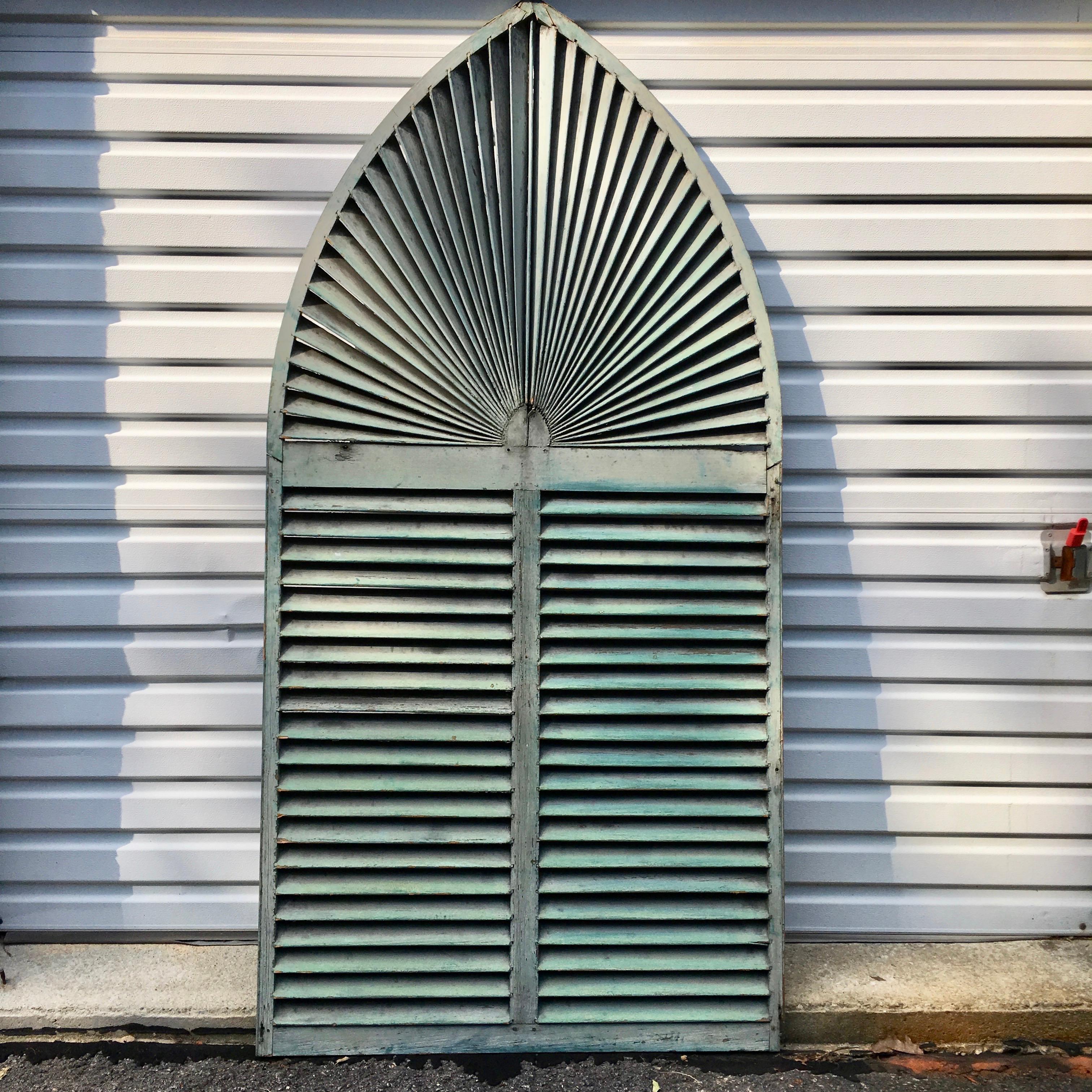 Currently in 1stdibs SATURDAY SALE

Large size fan louvered exterior window shutter in original rustic distressed old paint, green on front, black on verso. 91 inches tall by 45.5 inches wide. The arched portion begins 52 inches from the bottom.