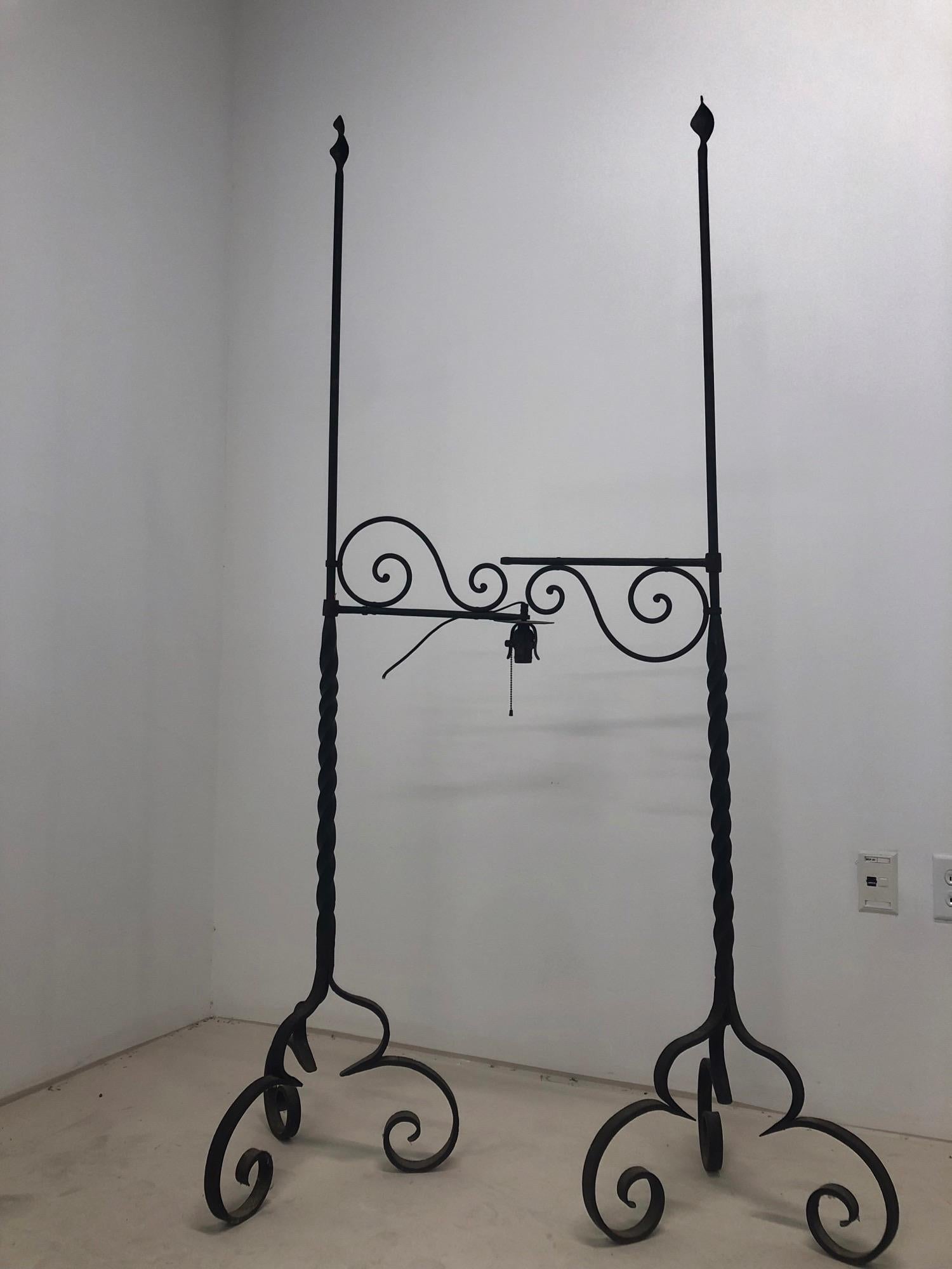 A pair of Gothic wrought iron floor lamp/candlestands from the 19th century.