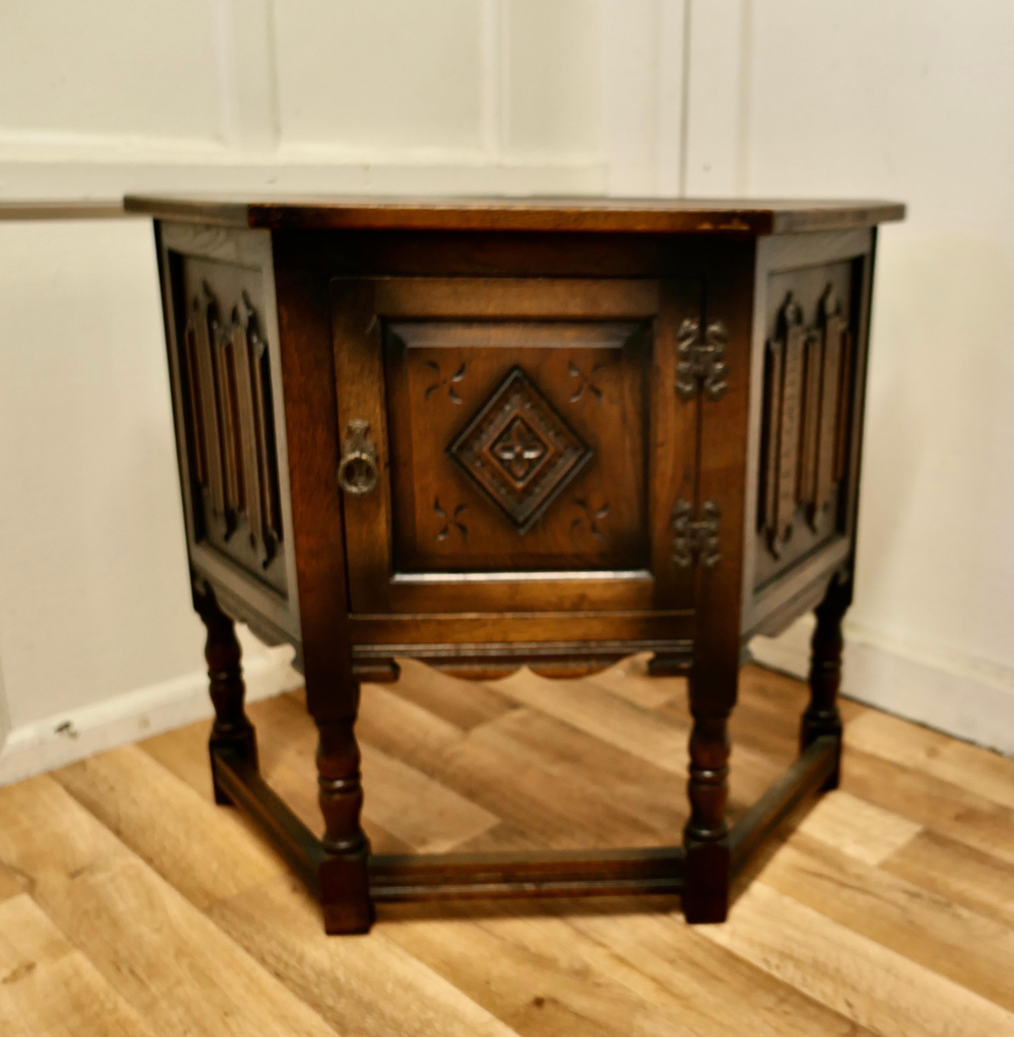 Gothic Carved Oak Credence cupboard by Old Charm

A Charming little piece dating from about 1920, the cabinet is known as a credence cupboard as it has such an unusual shape and a single door
The Cupboard is made by Old Charm, a company know for