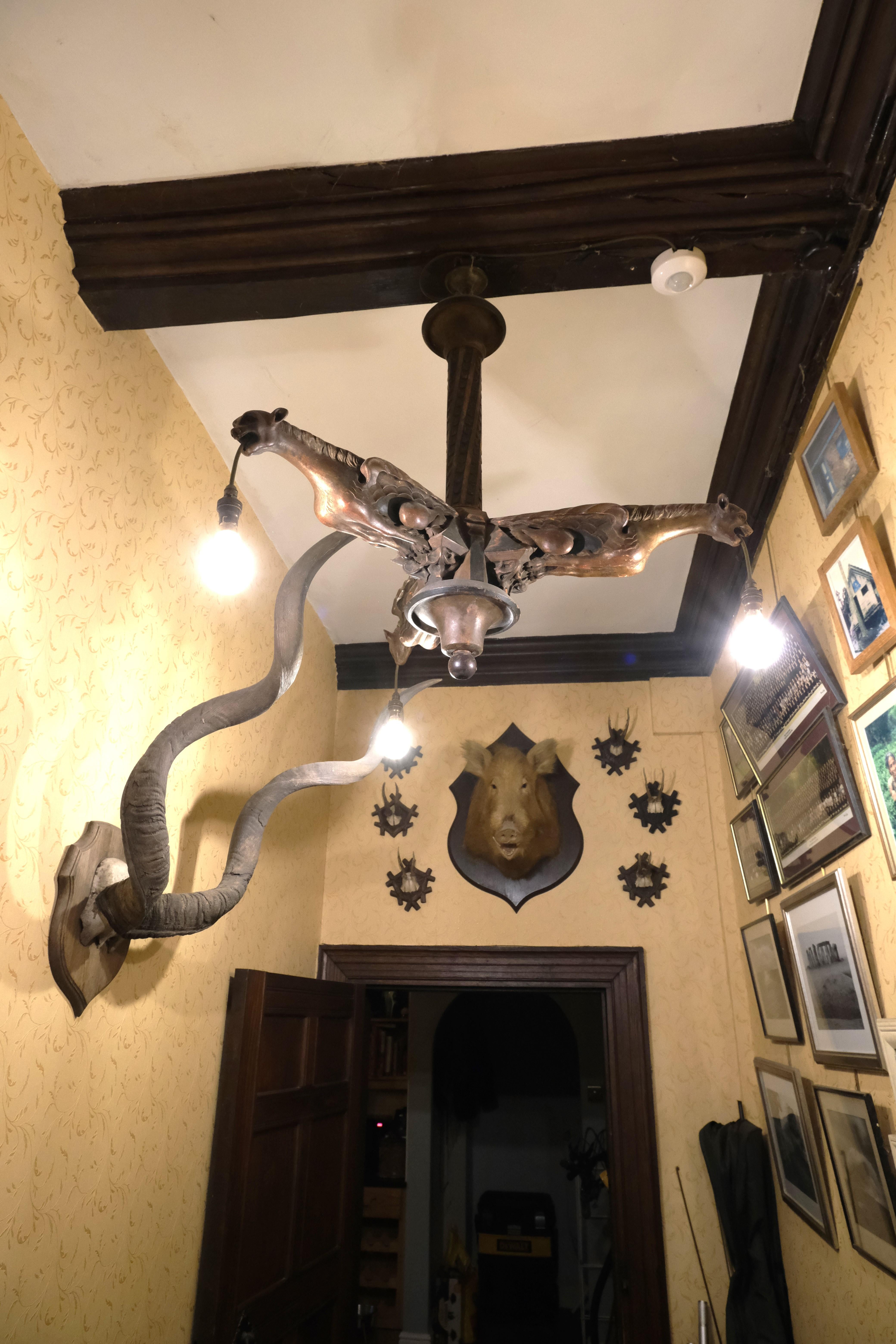 Hutton-Clarke Antiques takes great delight in presenting an extraordinary French Gothic carved wood chandelier dating back to approximately 1920. Meticulously crafted, this exquisite piece showcases a remarkable level of artistry and attention to