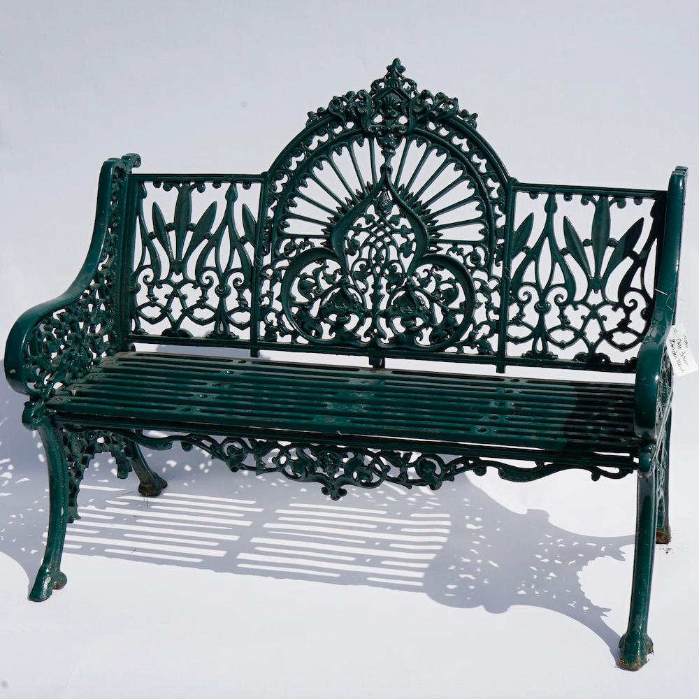 A Gothic style garden bench offers painted cast iron construction with stylized sunburst, foliate and scroll elements throughout, 20th century

Measures- 37.25''H x 48.75''W x 25.25''D