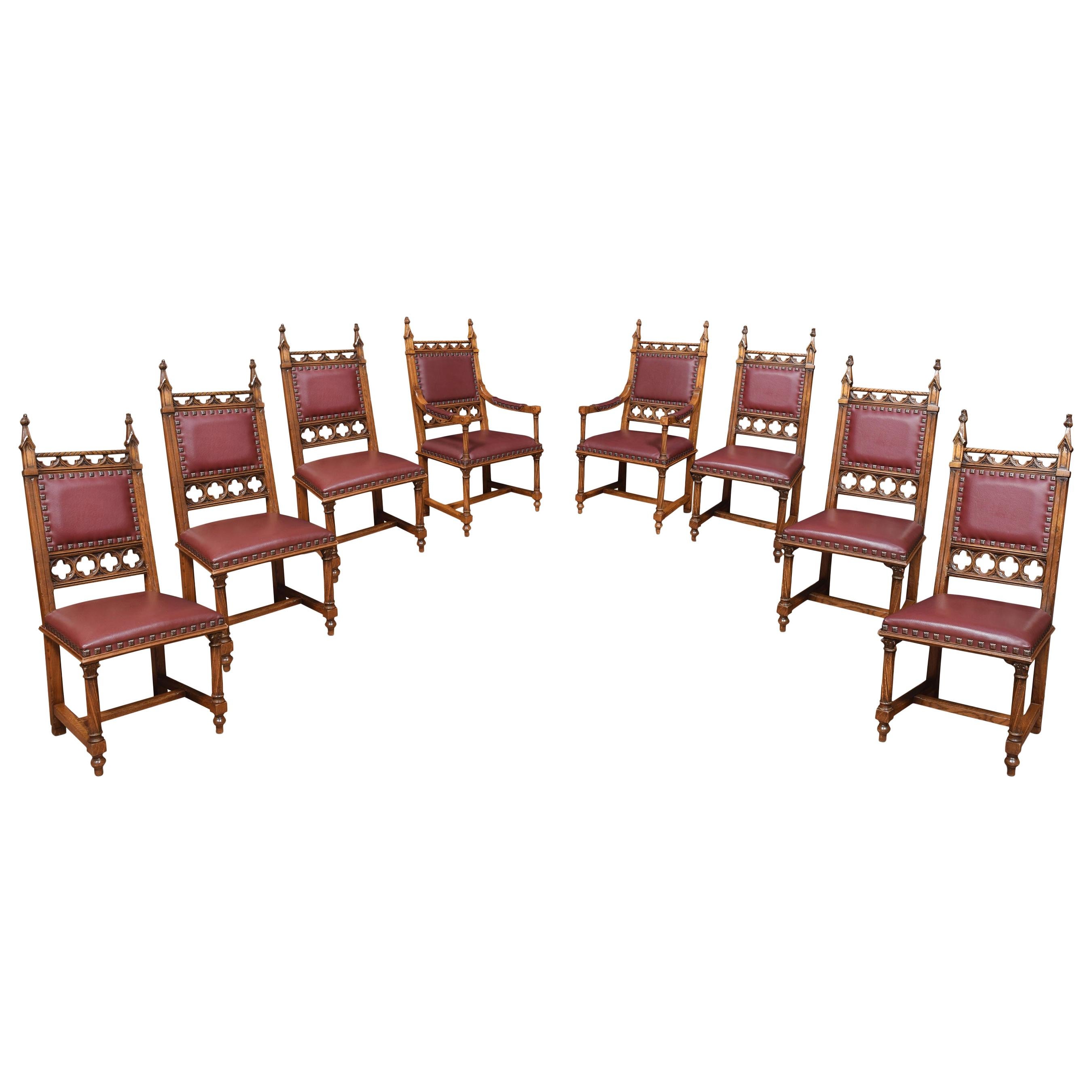 Oak refectory table having large rectangular planked top over pierced frieze. All raised up on spiral turned and stretchered supports united by stretcher.
The eight chairs comprising of two armchairs and six side chairs having carved finials above