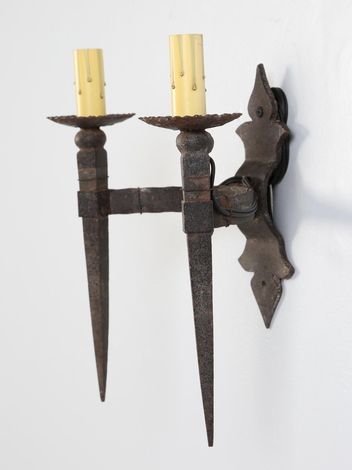 Old two-light handmade French sconce in the Gothic design and because this Gothic sconce was entirely hand-fabricated, it is almost impossible to date.